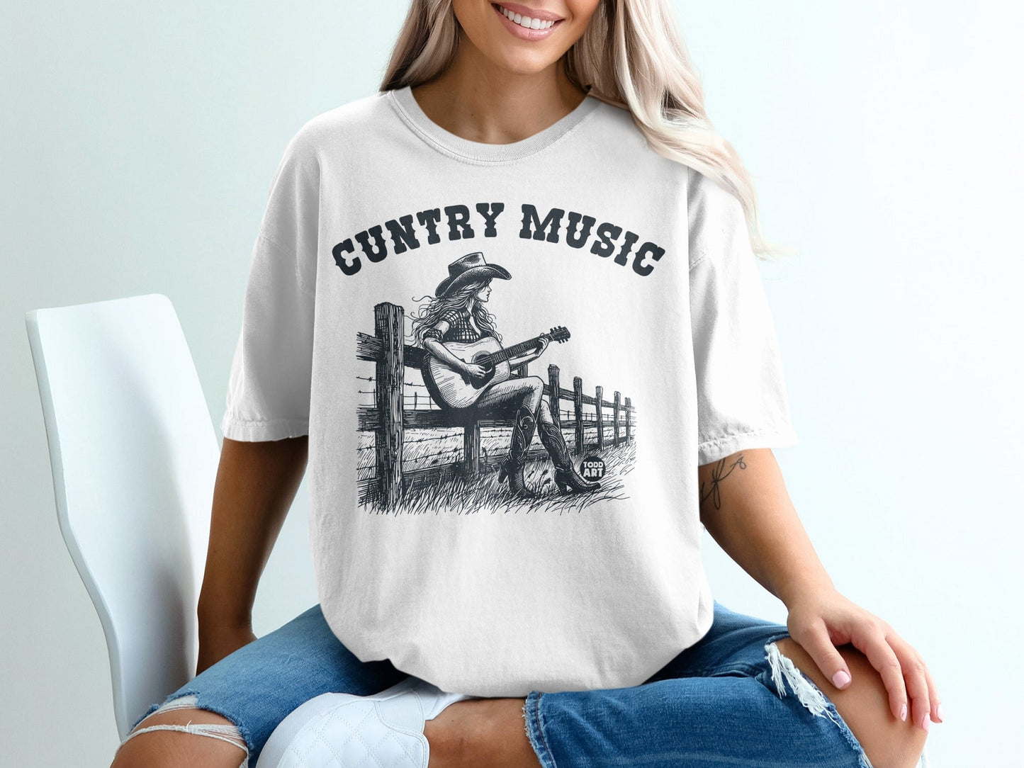 Graphic tee with "COUNTRY MUSIC" text and woman playing guitar.
