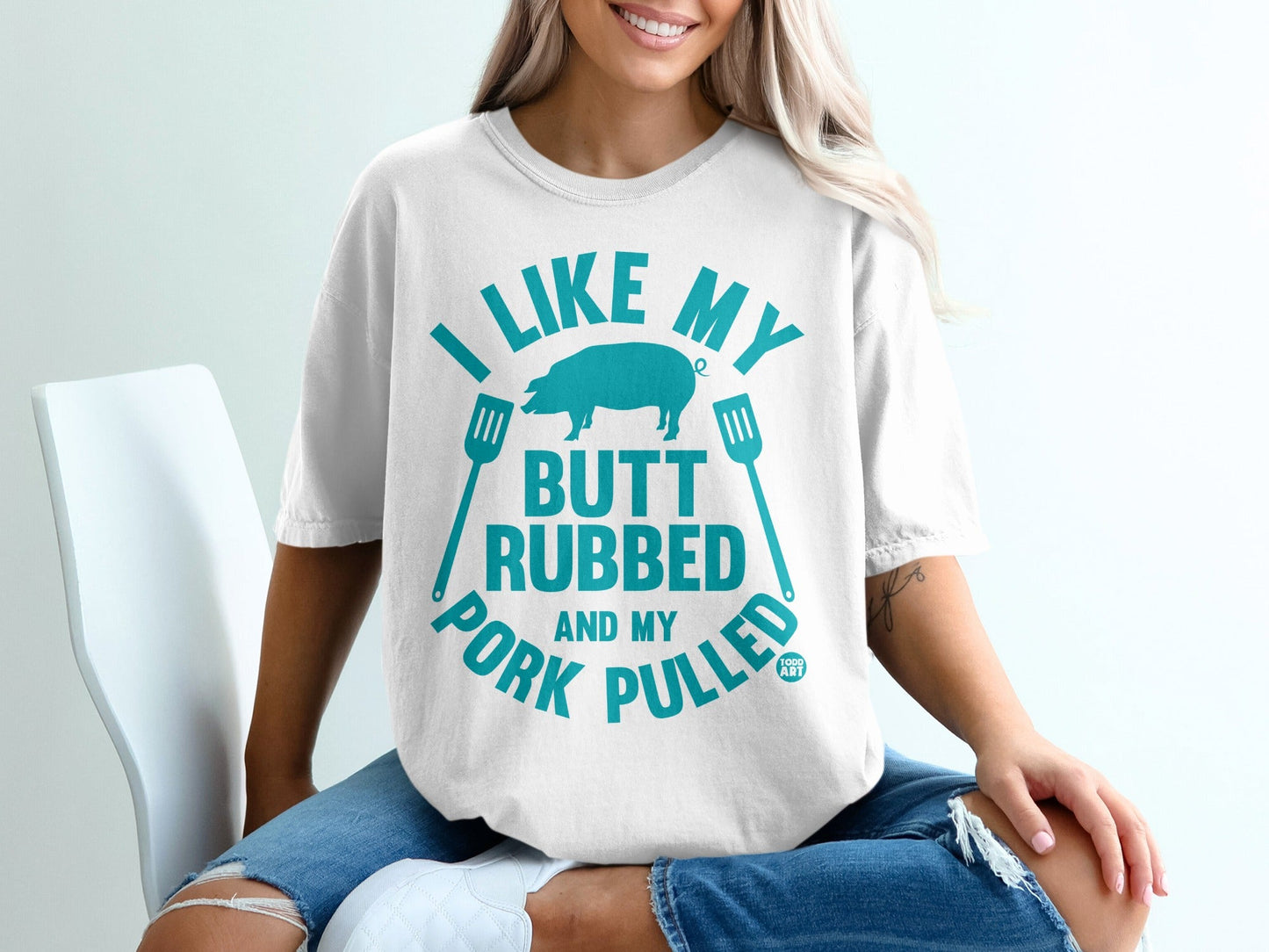 Blue t-shirt with "I like my butt rubbed and my pork pulled" text and pig graphic.