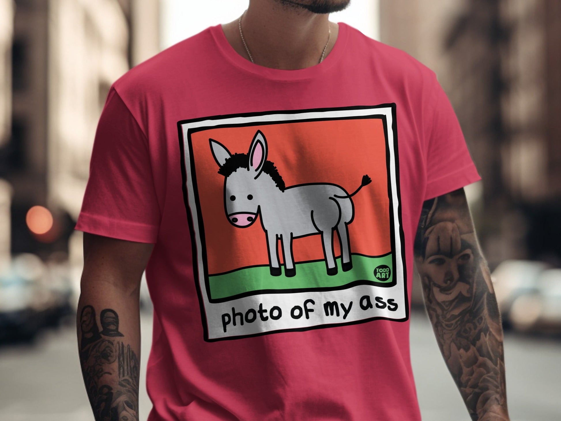Pink t-shirt with a cartoon donkey illustration and the text "photo of my ass".