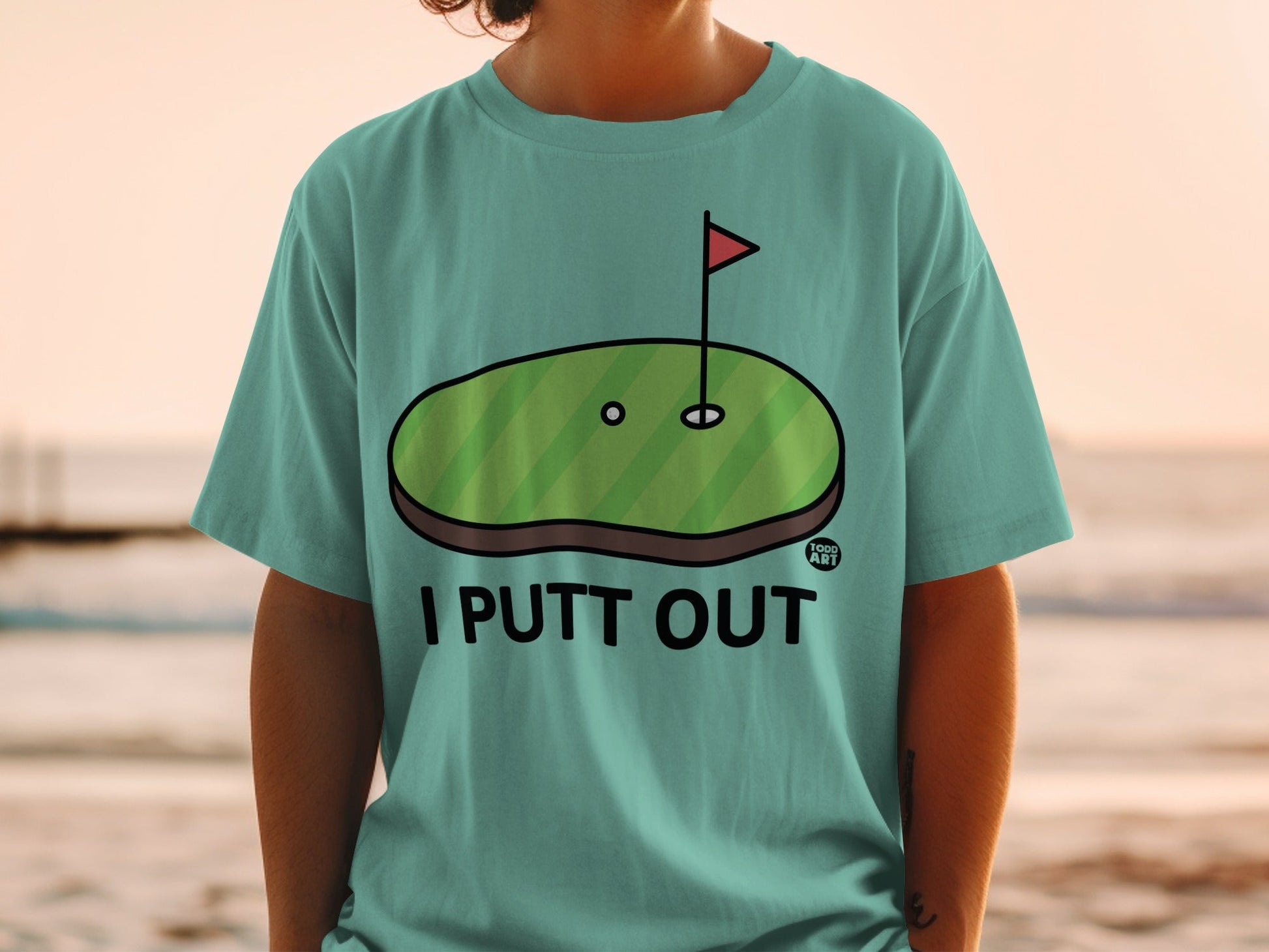 Green golf putting green with hole and flag, text "I PUTT OUT".