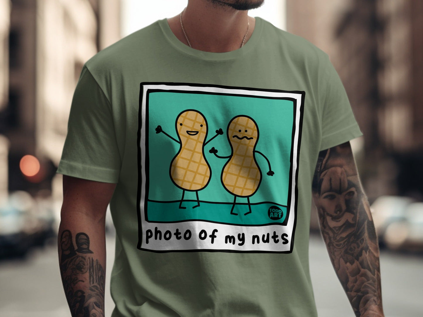 T-shirt with cartoon peanuts saying "photo of my nuts" and "food art".