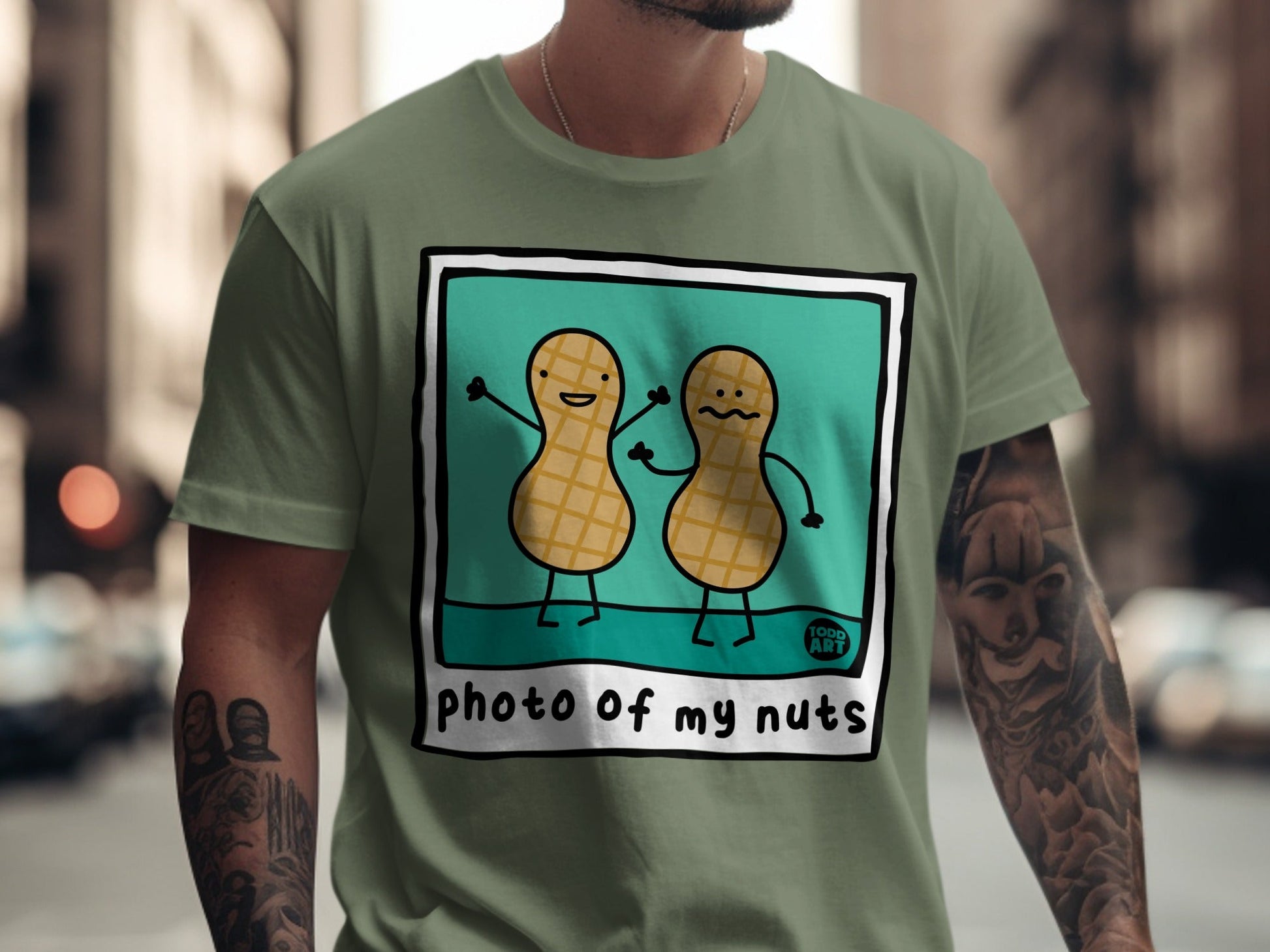T-shirt with cartoon peanuts saying "photo of my nuts" and "food art".