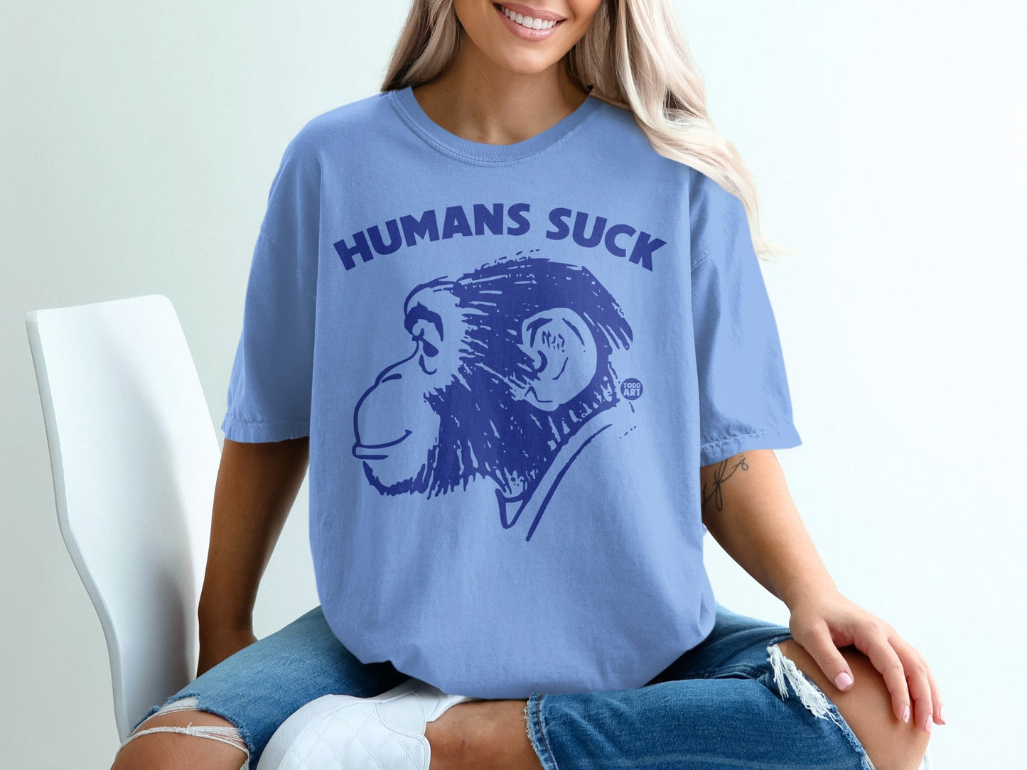 Light blue t-shirt with "HUMANS SUCK" and chimpanzee graphic.