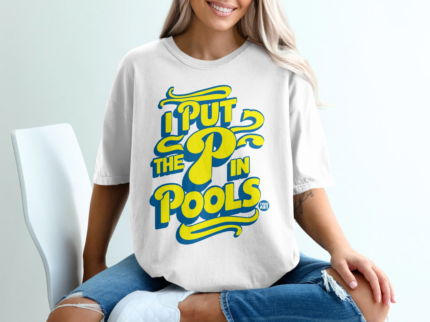 White t-shirt with yellow and blue "I PUT THE P IN POOLS" text.