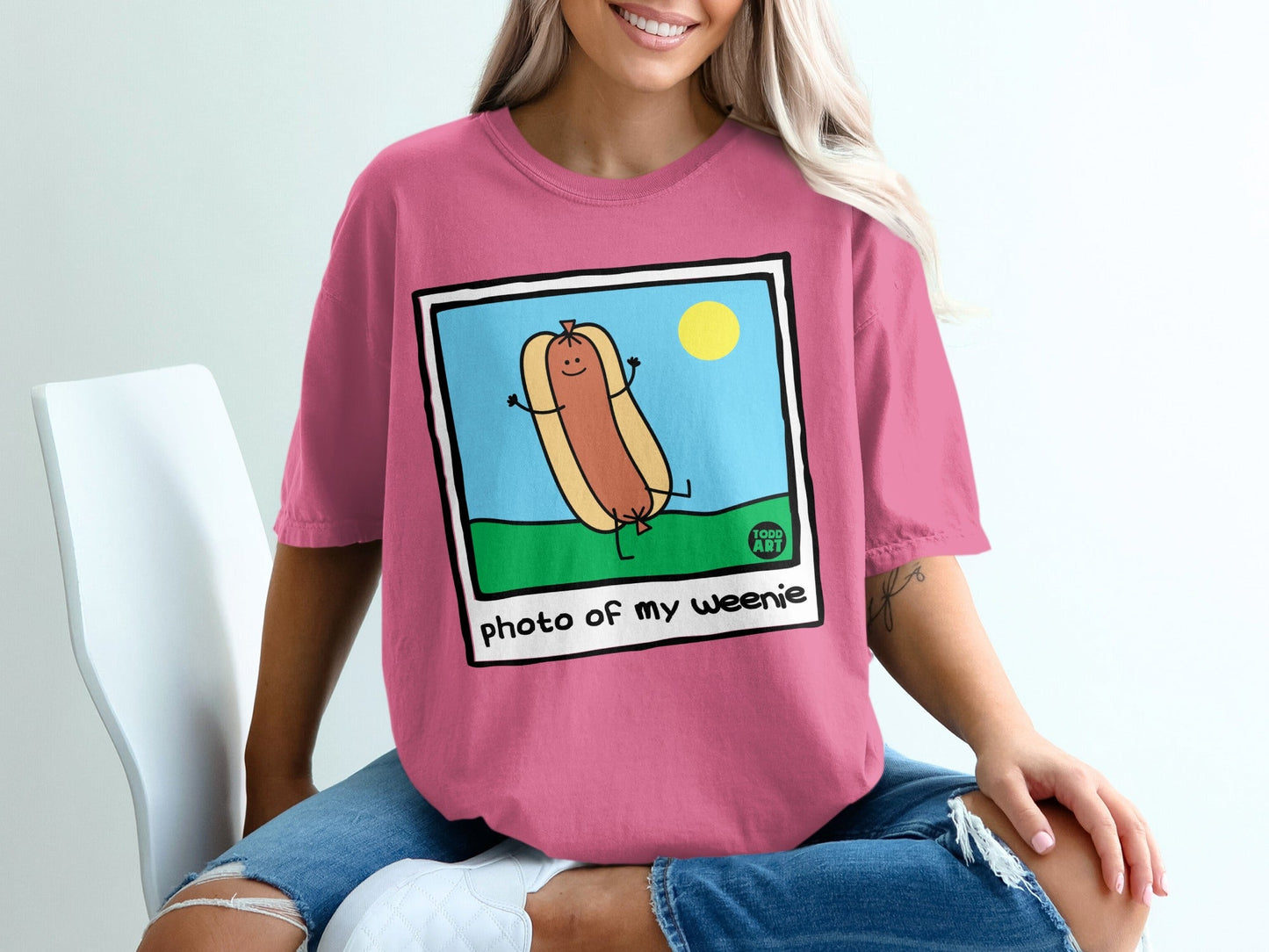 Pink t-shirt with cartoon hot dog and "photo of my weenie" text.