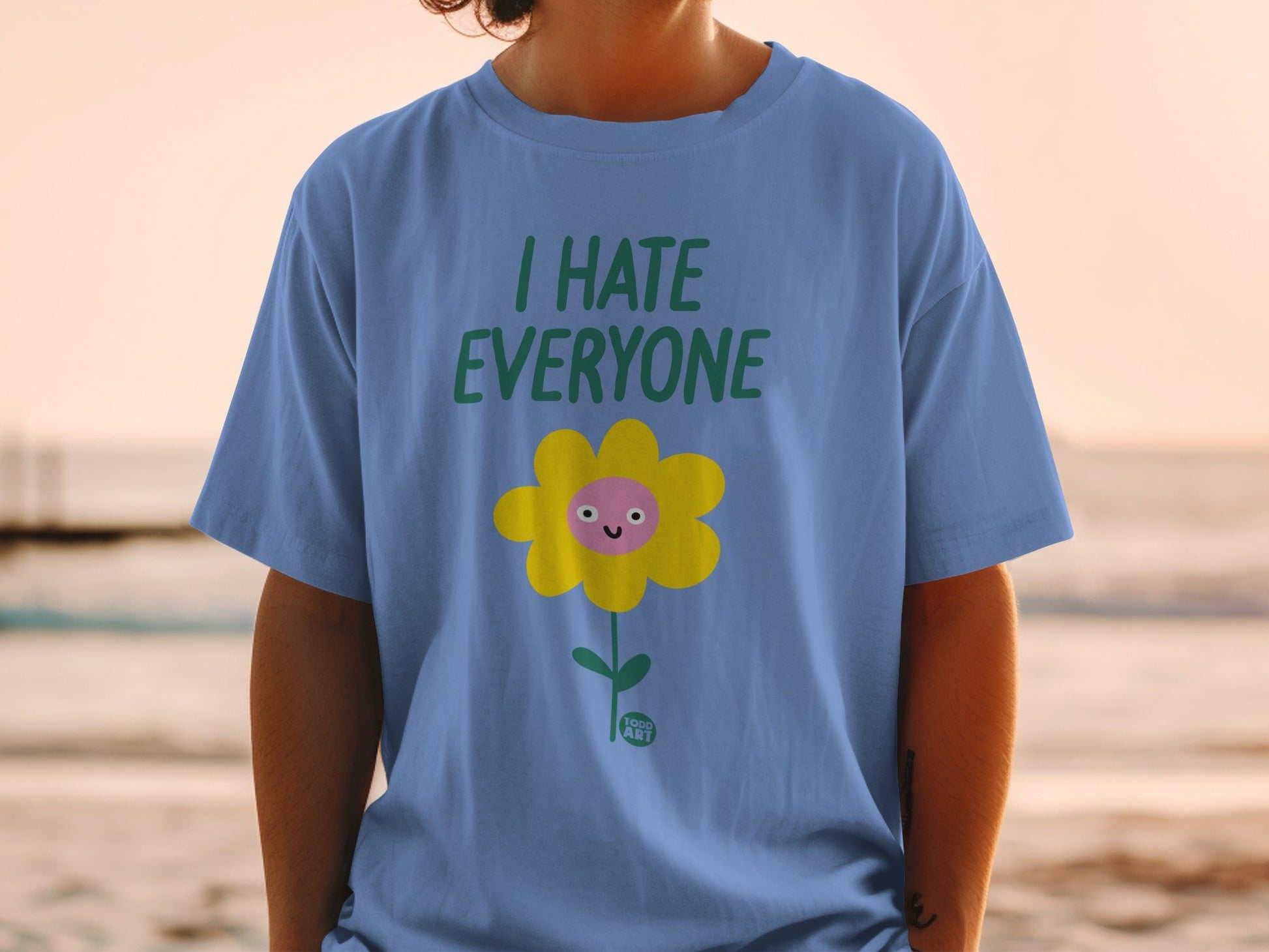 Blue t-shirt with "I HATE EVERYONE" and a smiling flower.
