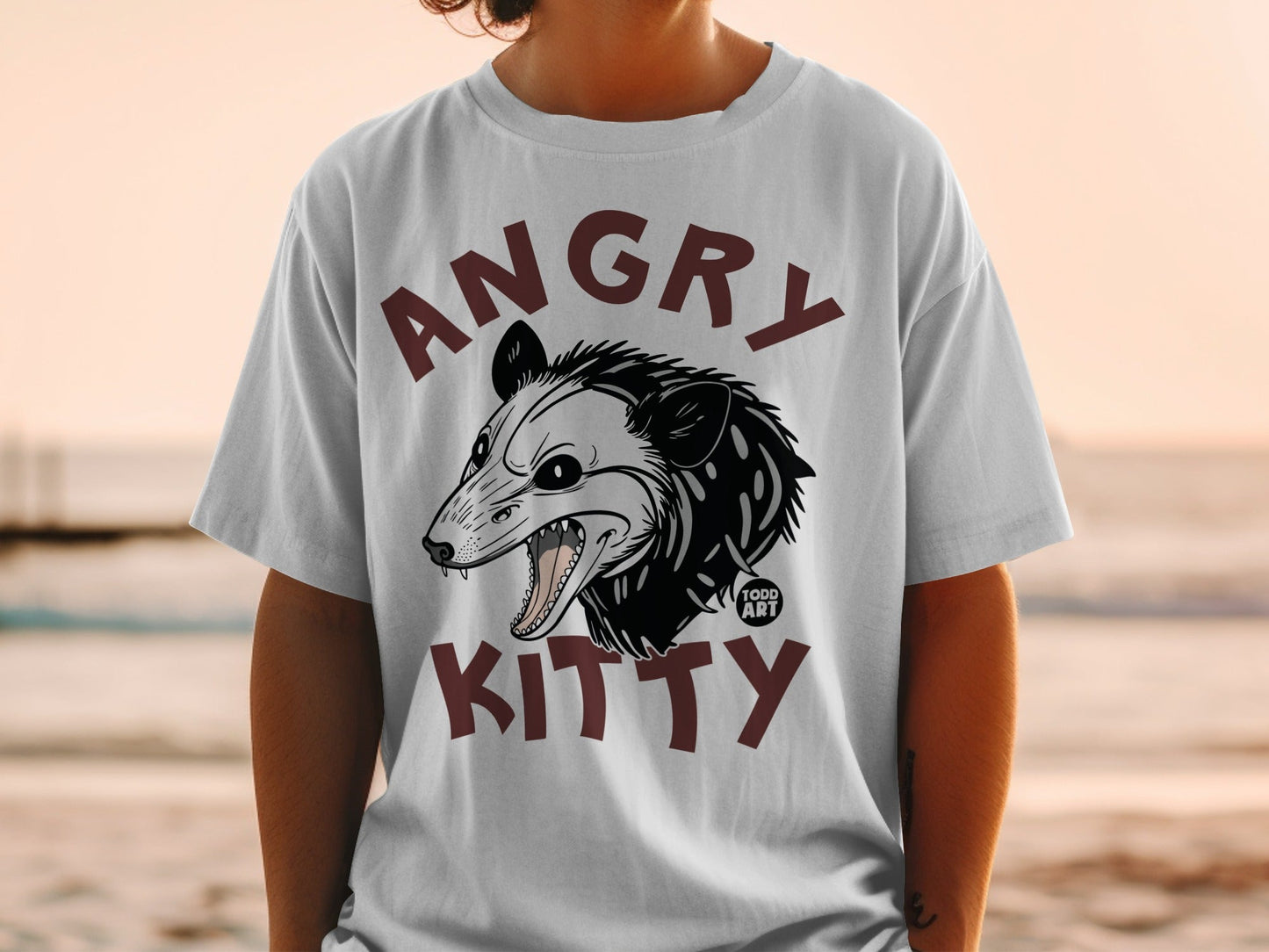 White t-shirt with an angry possum illustration and "Angry Kitty" text.