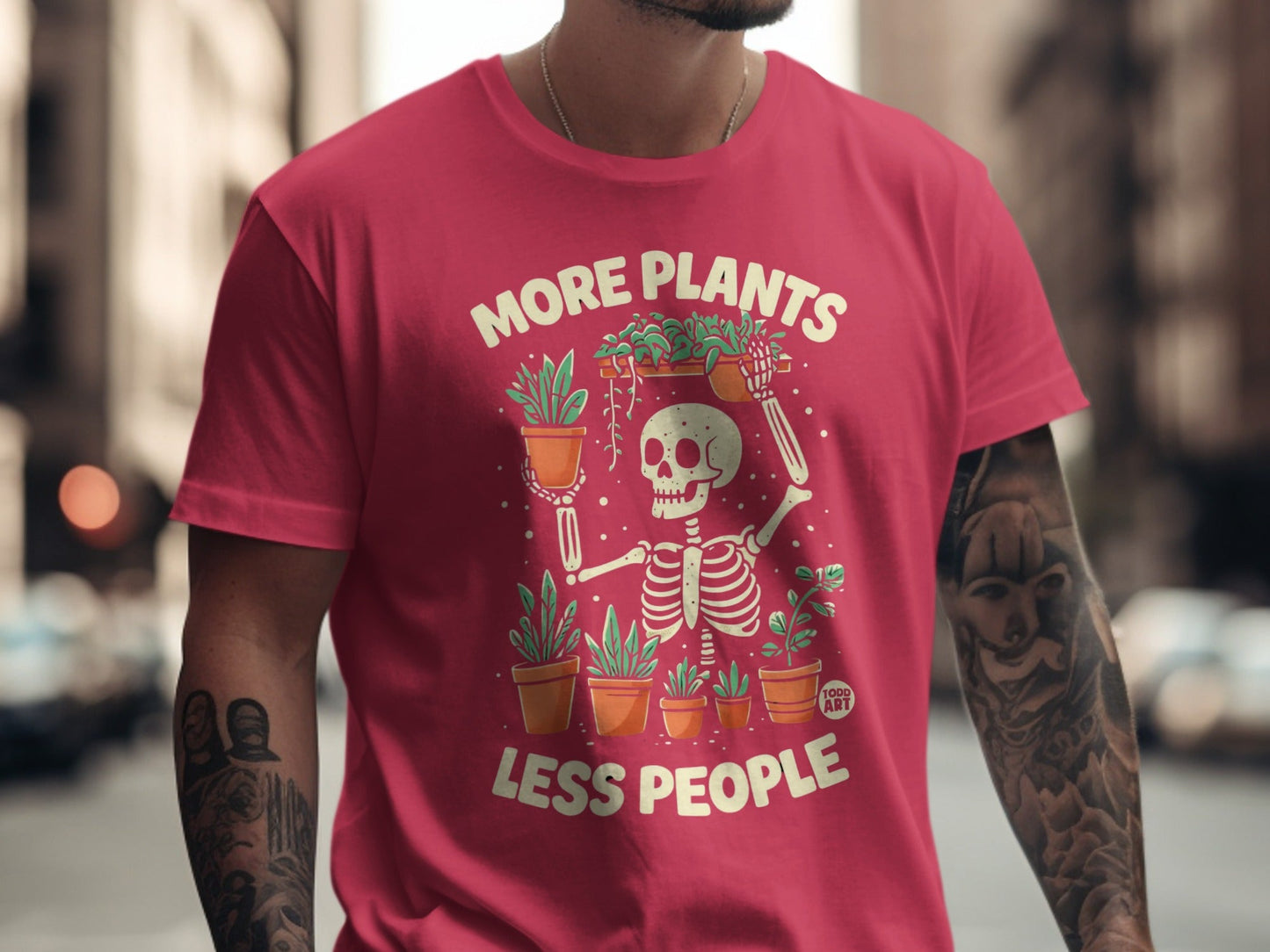 Red t-shirt with skeleton holding plants and text "MORE PLANTS LESS PEOPLE".