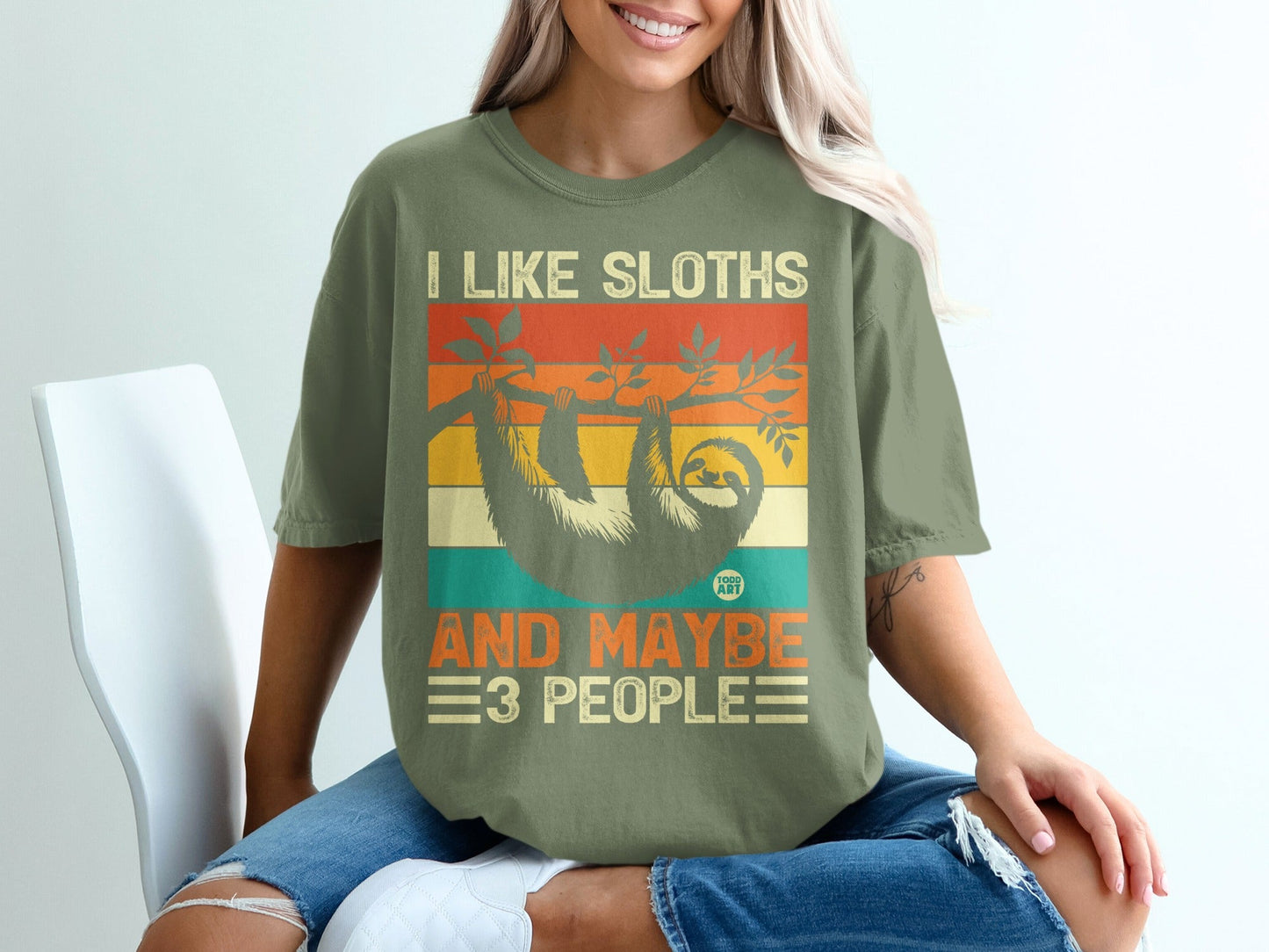 Green t-shirt with vintage-style "I Like Sloths And Maybe 3 People" graphic.