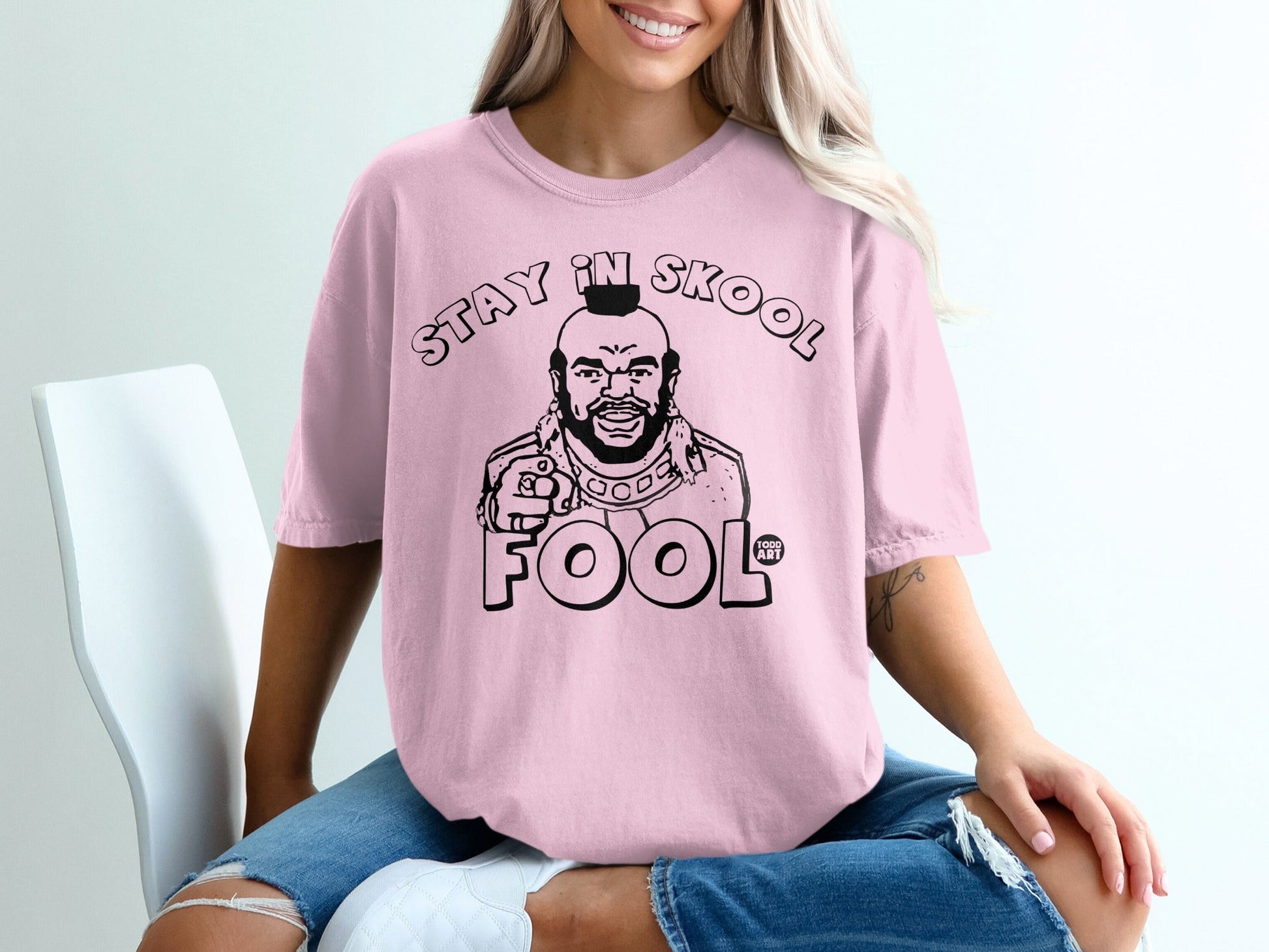 Pink t-shirt with black graphic of Mr. T saying "Stay in Skool Fool".
