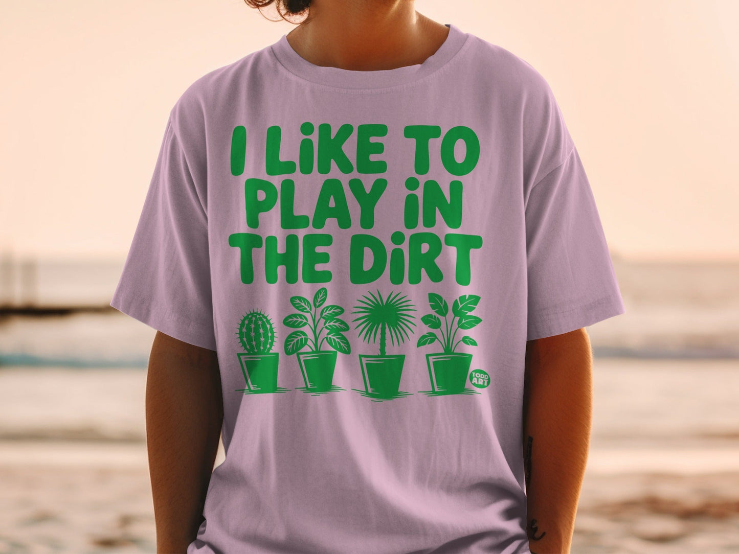 T-shirt with "I LIKE TO PLAY IN THE DIRT" and potted plants.