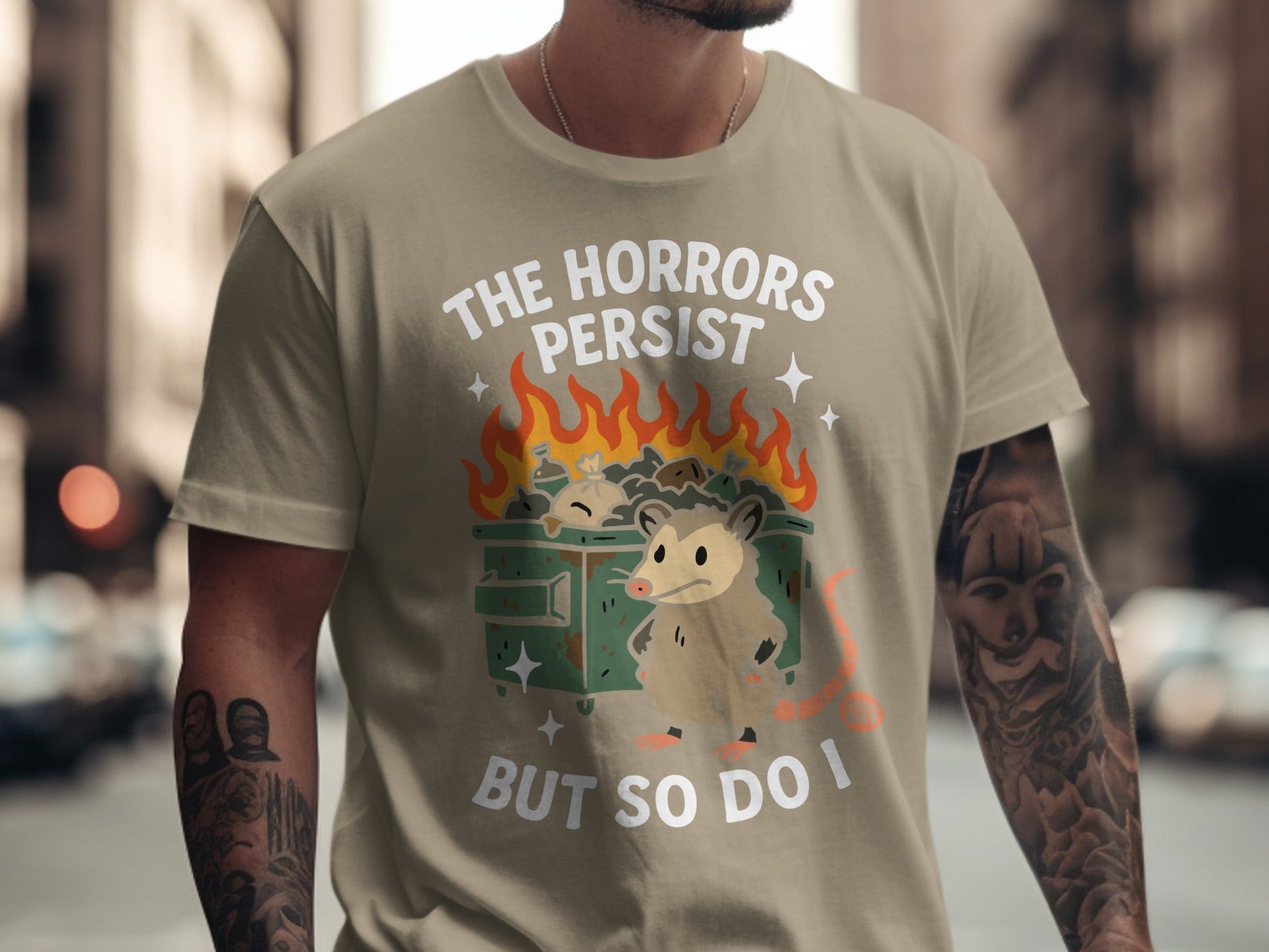 Opossum in burning dumpster shirt with text "The Horrors Persist But So Do I".