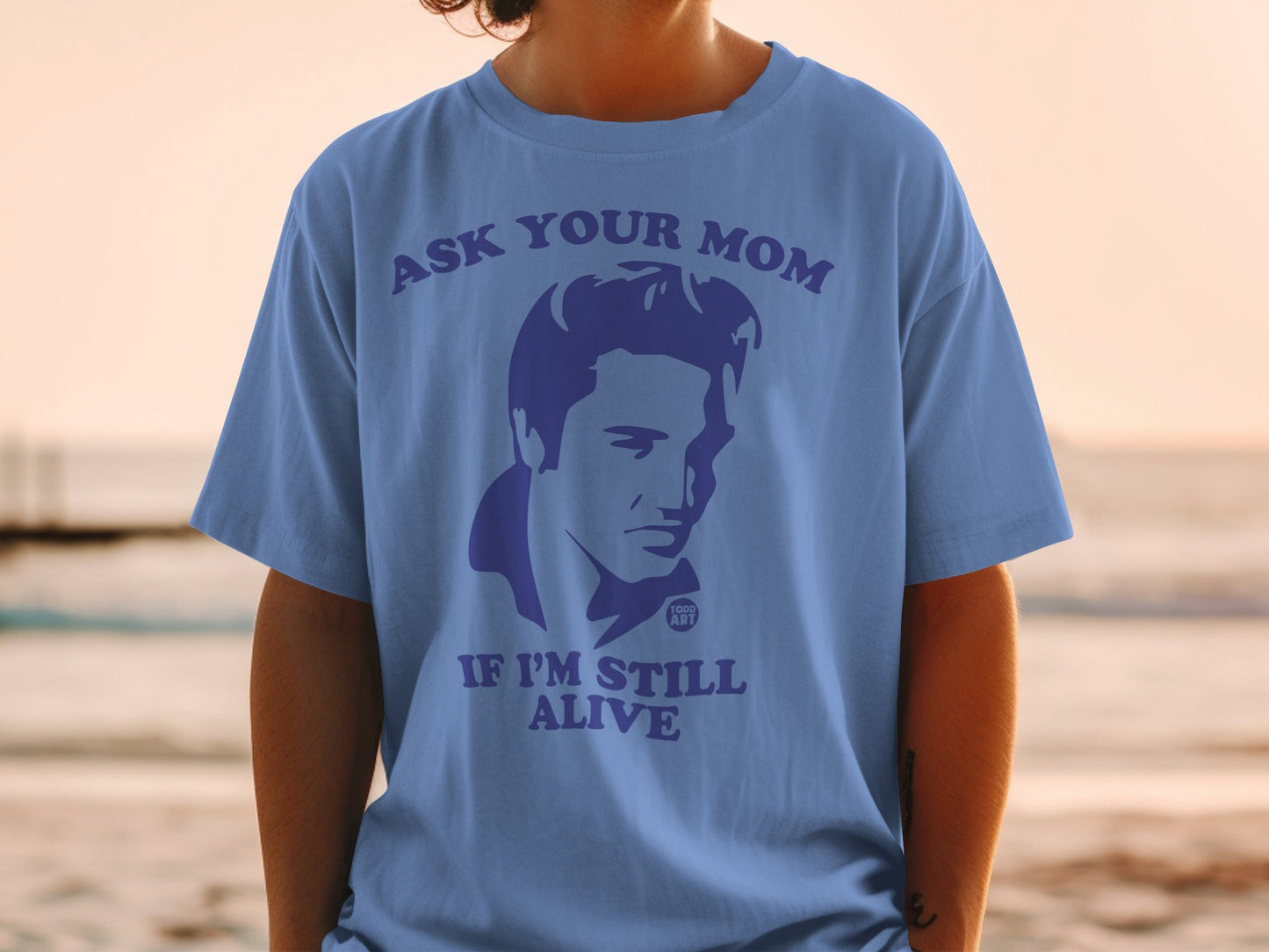 Blue t-shirt with "Ask Your Mom If I'm Still Alive" and Elvis Presley graphic.