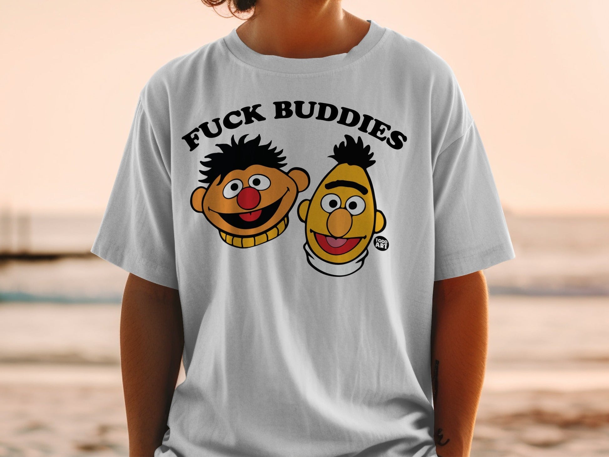White t-shirt with "FUCK BUDDIES" text and cartoon characters Bert and Ernie.
