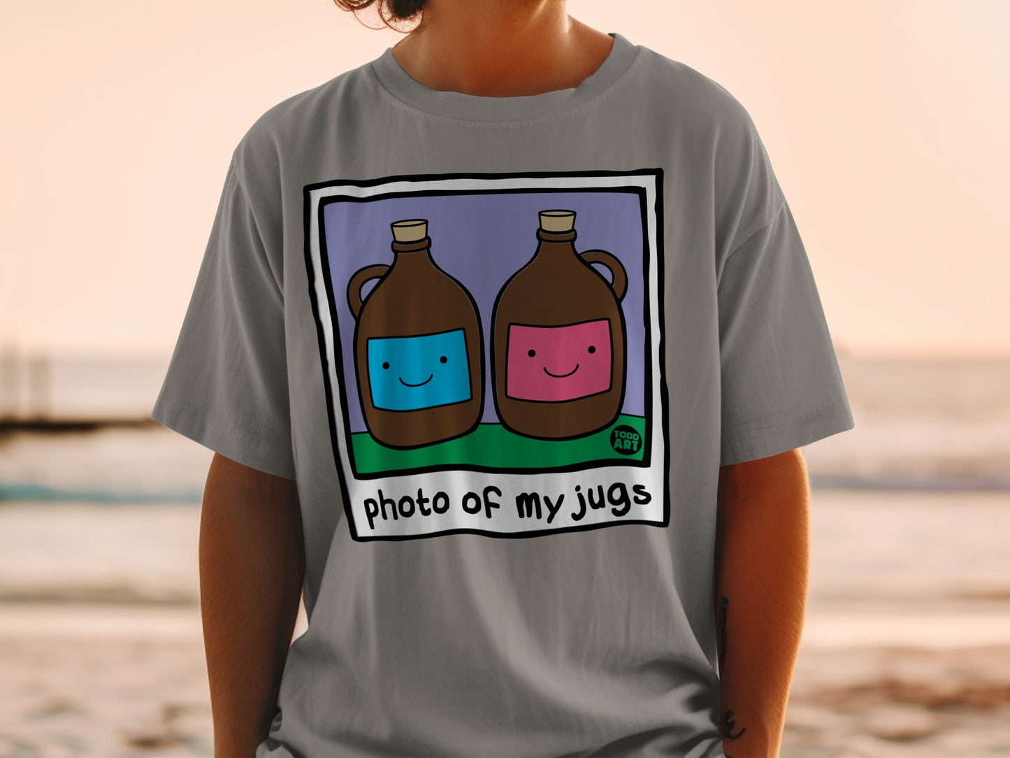 Two jugs, one blue, one pink, with cartoon faces, on a t-shirt.