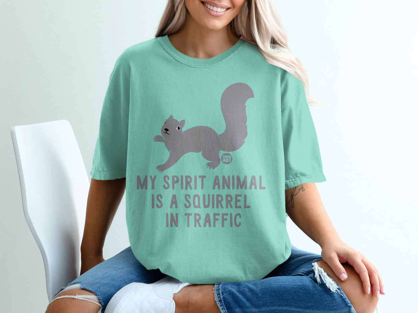 Mint t-shirt with a squirrel graphic and text "My spirit animal is a squirrel in traffic."