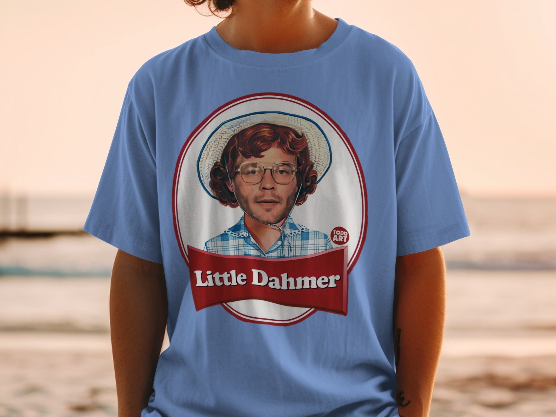 Blue t-shirt featuring a portrait of Jeffrey Dahmer with "Little Dahmer" text.