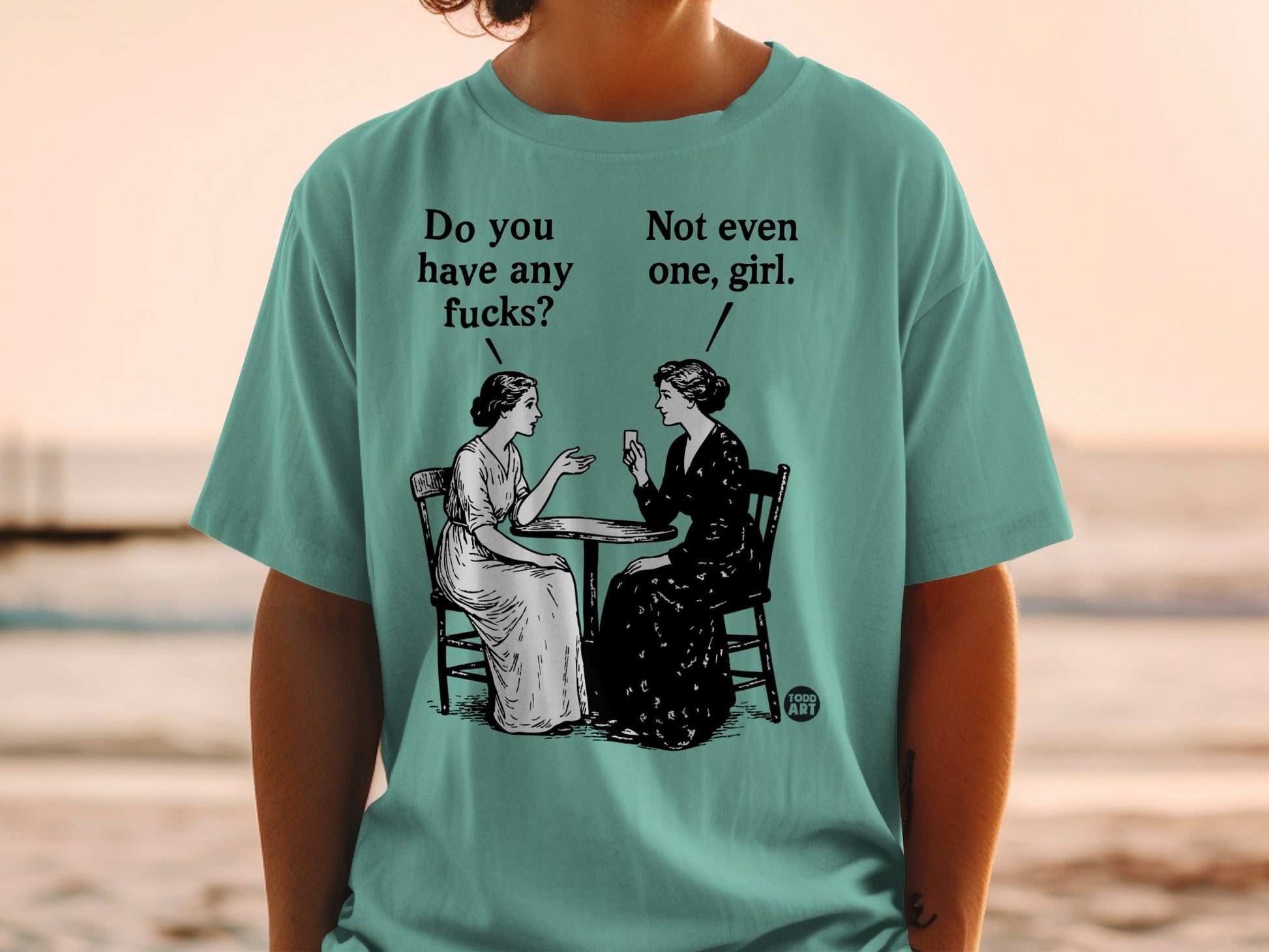 Two women at a table with text "Do you have any fucks?" and "Not even one, girl."