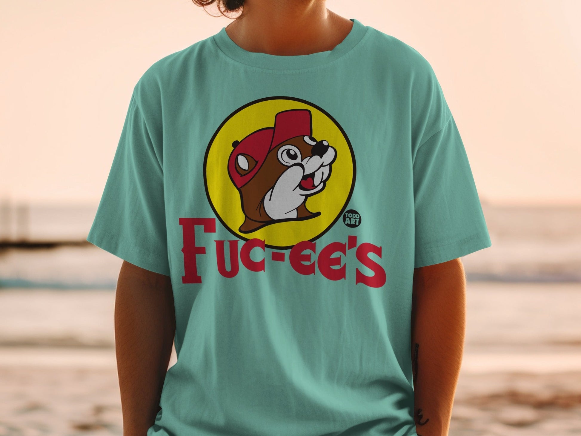 Teal t-shirt featuring Bucee's logo with beaver character and red cap.