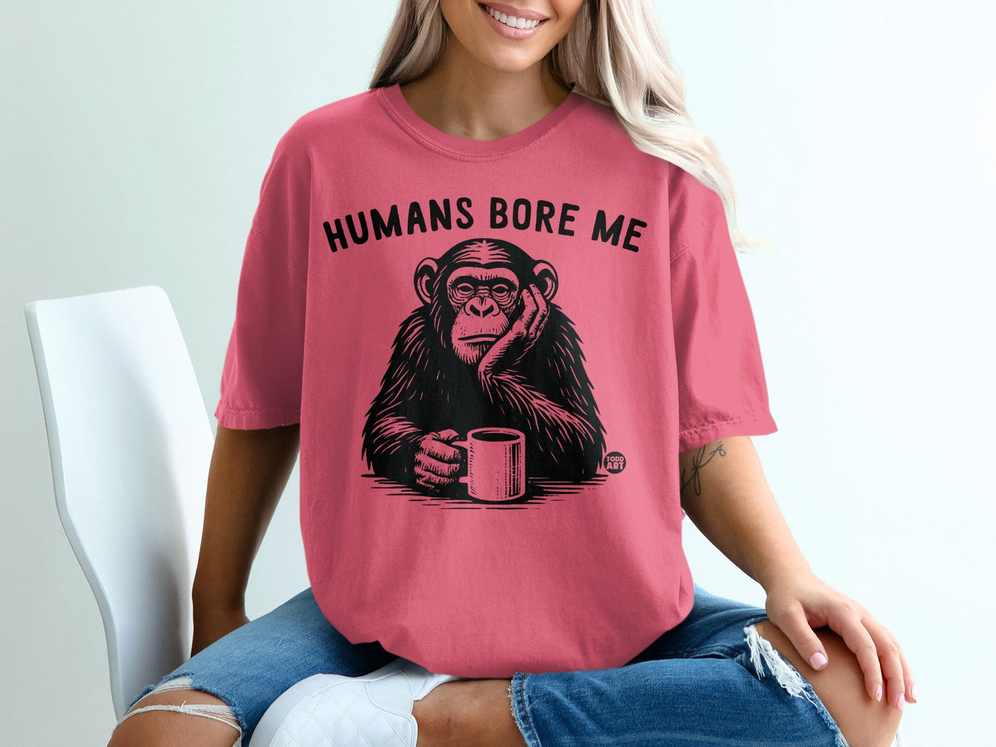Chimpanzee with text "HUMANS BORE ME" holding a coffee mug.