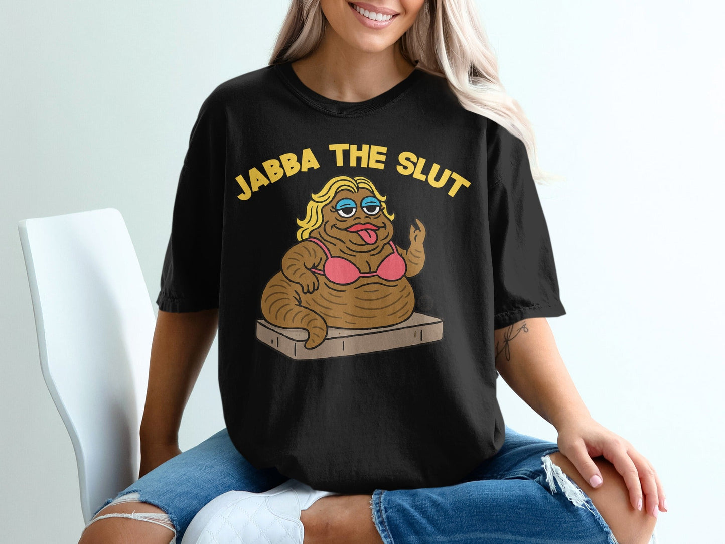 Black t-shirt with "JABBA THE SLUT" and cartoon Jabba the Hutt in a bikini.