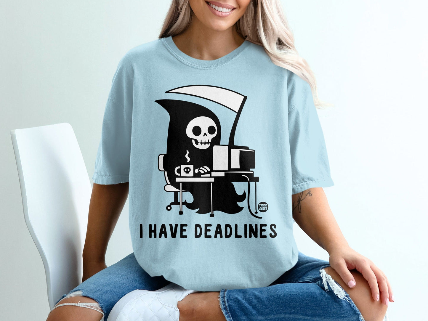 Light blue t-shirt with a grim reaper at a computer; "I HAVE DEADLINES" text.