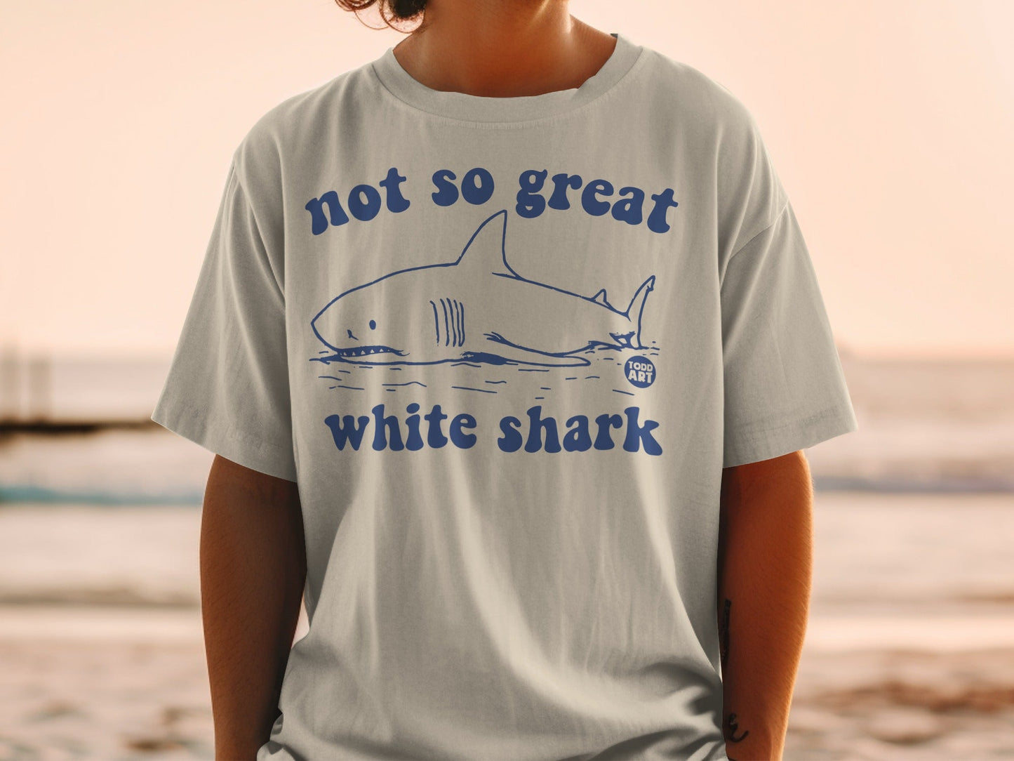 Light grey t-shirt with "not so great white shark" text and shark graphic.