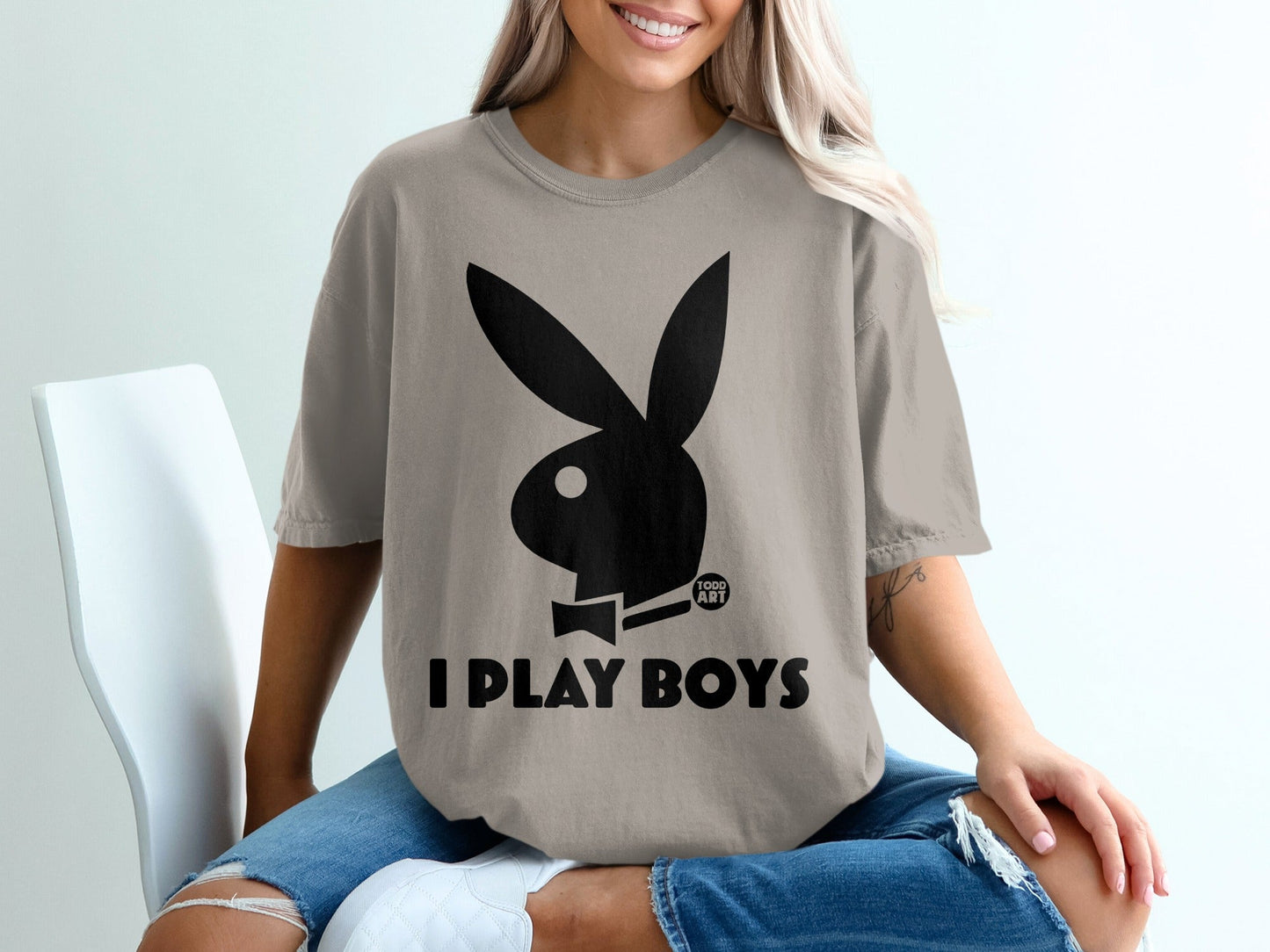 Tan t-shirt with black Playboy bunny logo and text "I PLAY BOYS".