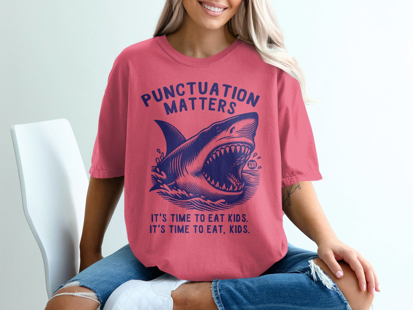 T-shirt with shark graphic and text "Punctuation Matters" and "It's Time to Eat Kids".
