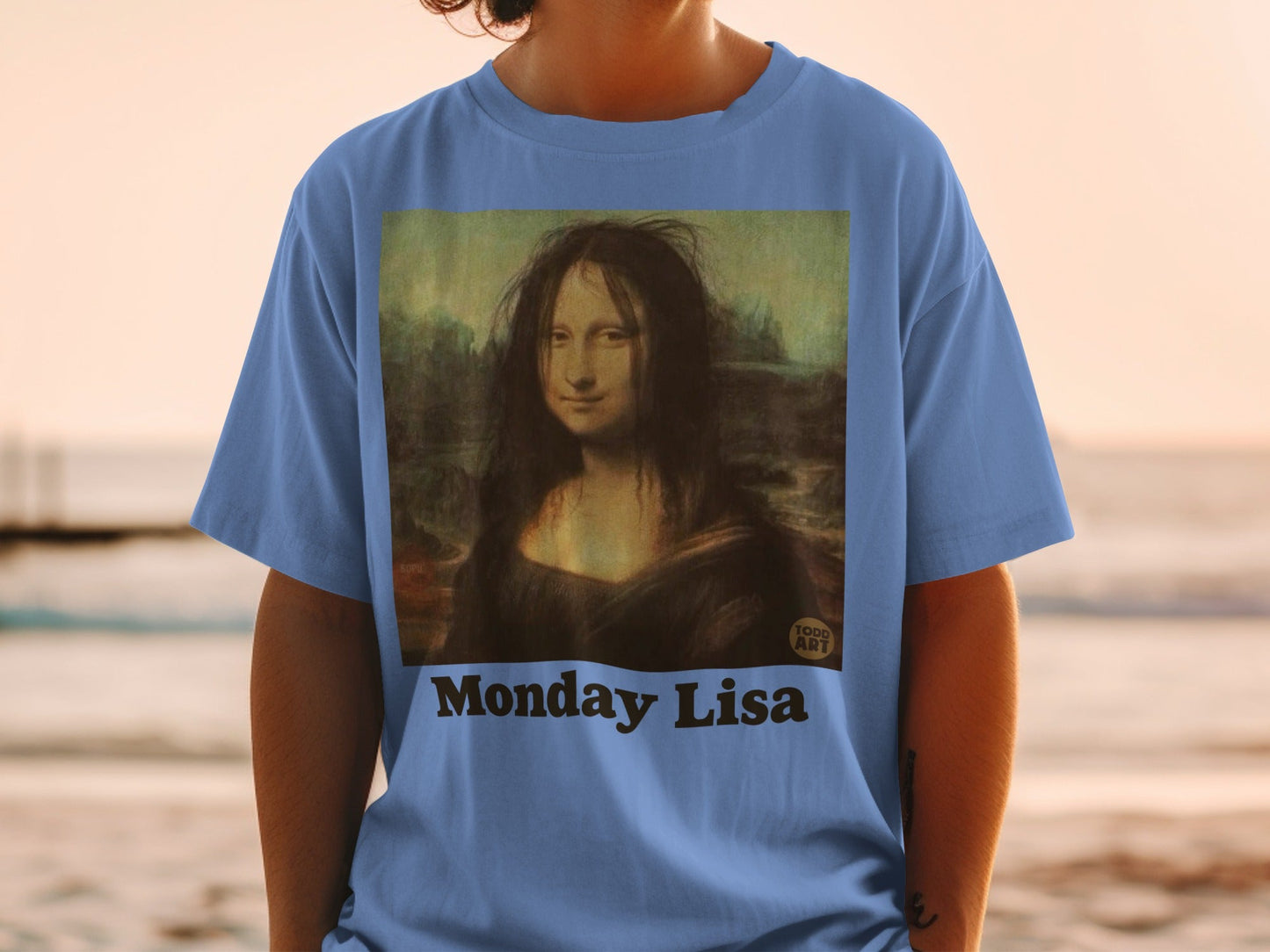 Blue t-shirt with "Monday Lisa" text and a Mona Lisa parody.