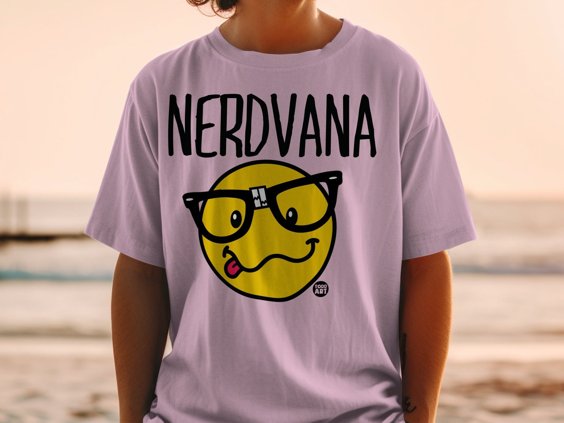 Pink t-shirt with "NERDVANA" text and yellow smiley face with glasses.