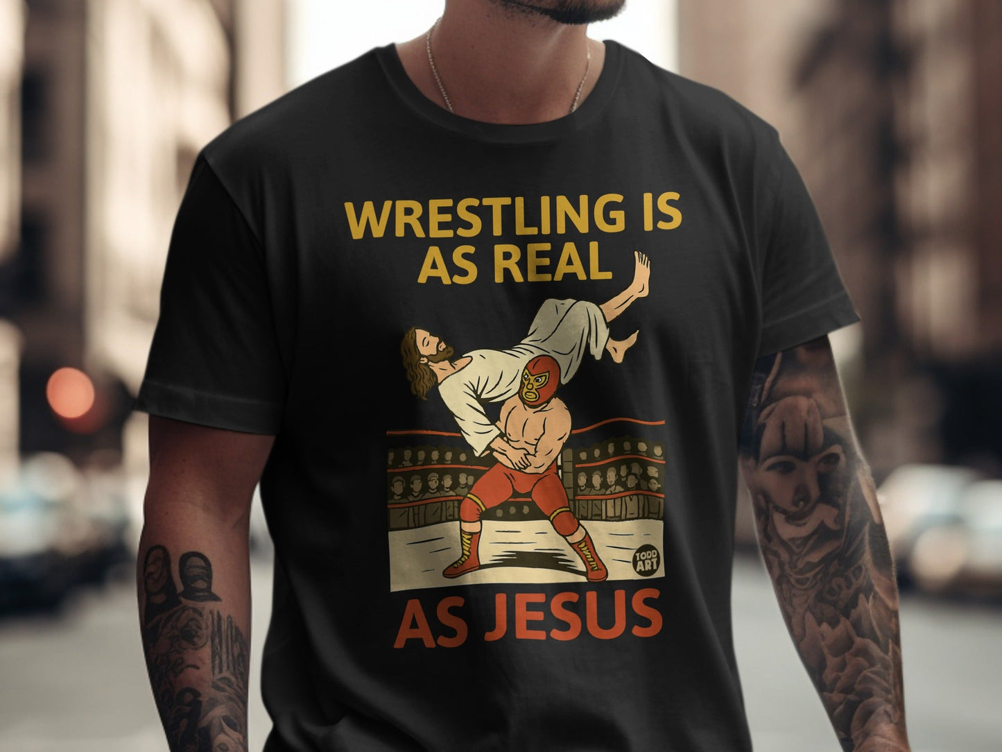 Wrestling is as real as Jesus graphic on a black t-shirt.
