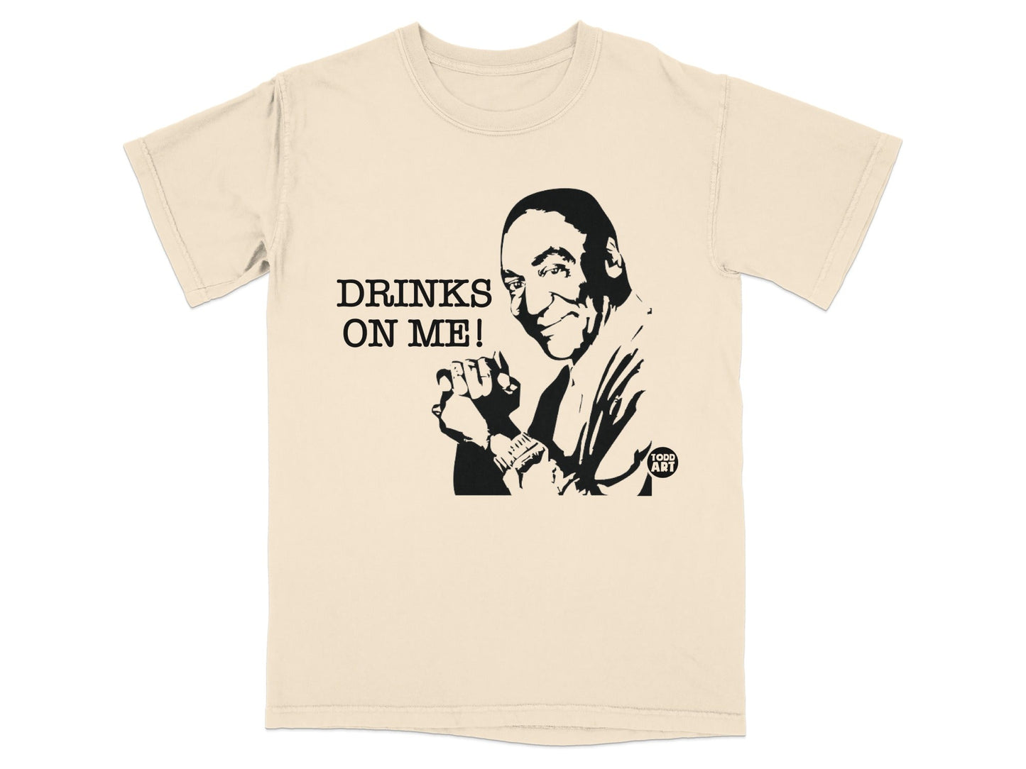 Cream t-shirt with black graphic of Bill Cosby and "DRINKS ON ME!" text.