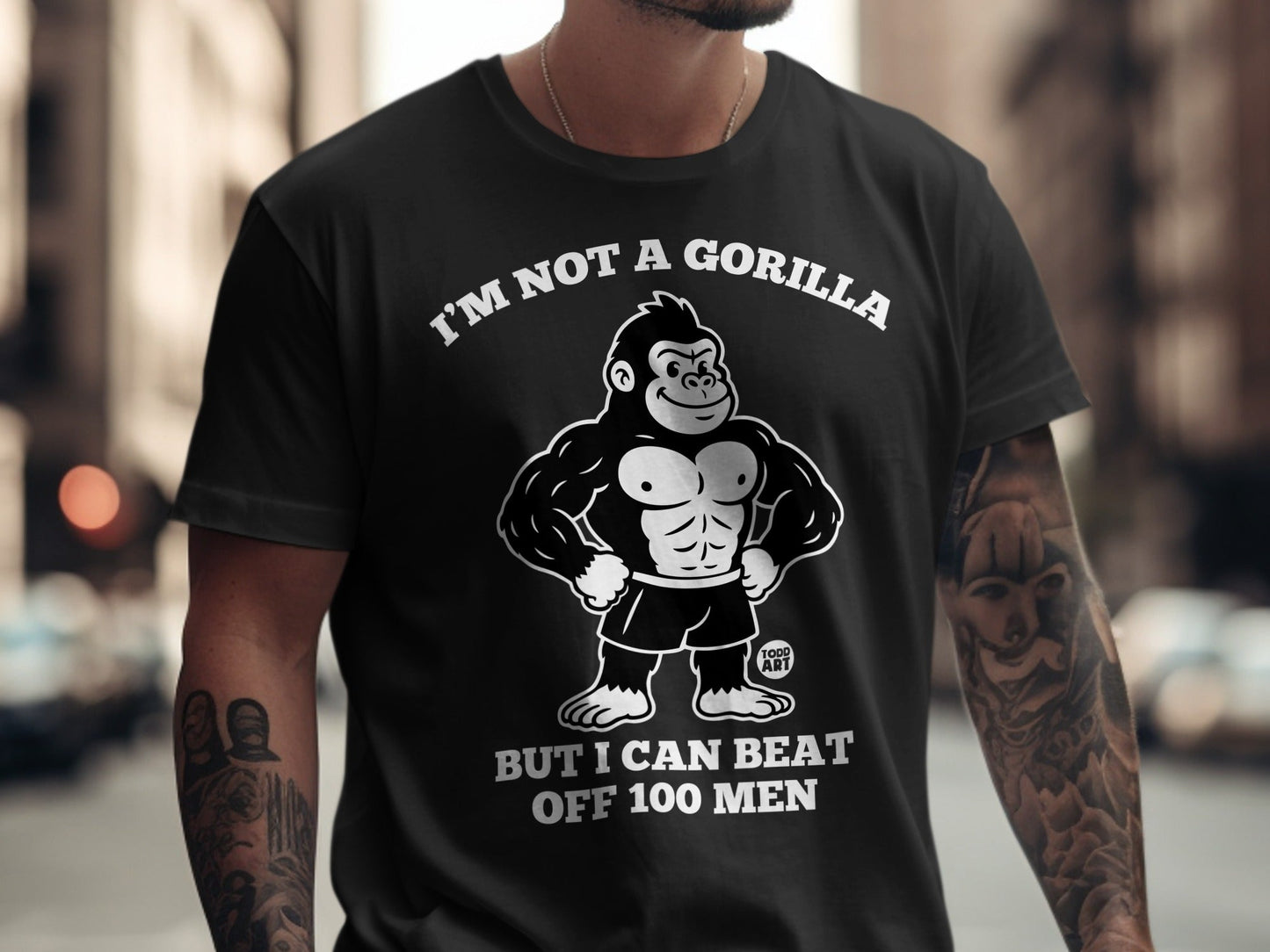 Black t-shirt with "I'm Not A Gorilla But I Can Beat Off 100 Men" and gorilla graphic.