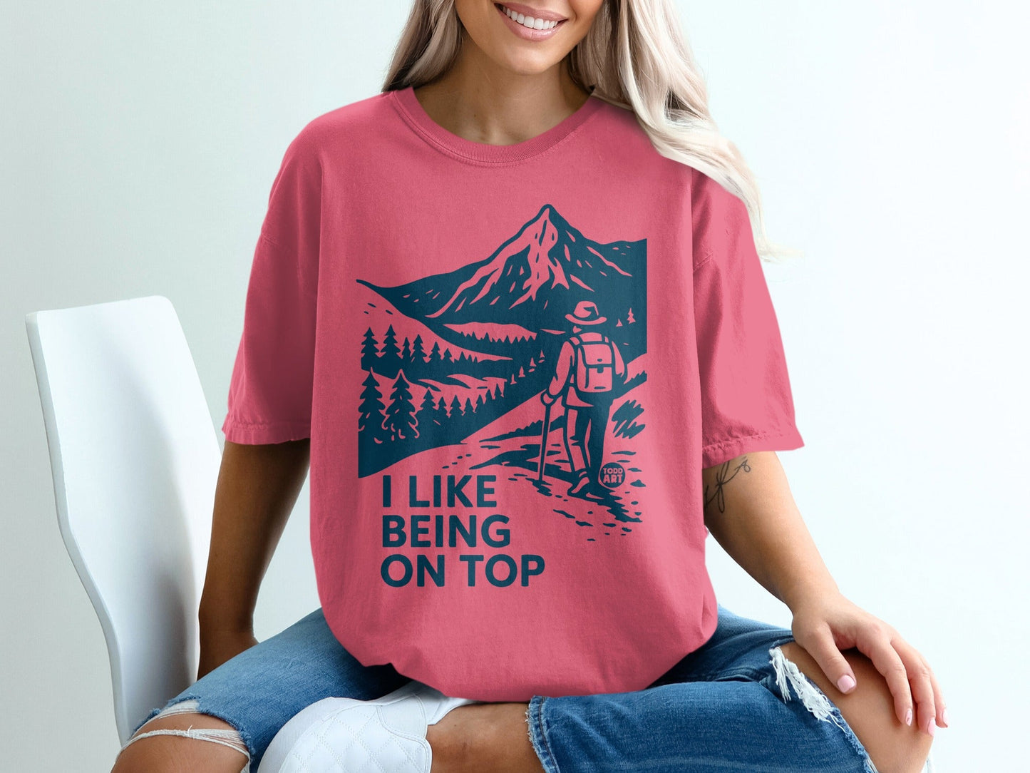 T-shirt with hiker and mountain graphic, "I LIKE BEING ON TOP" text.