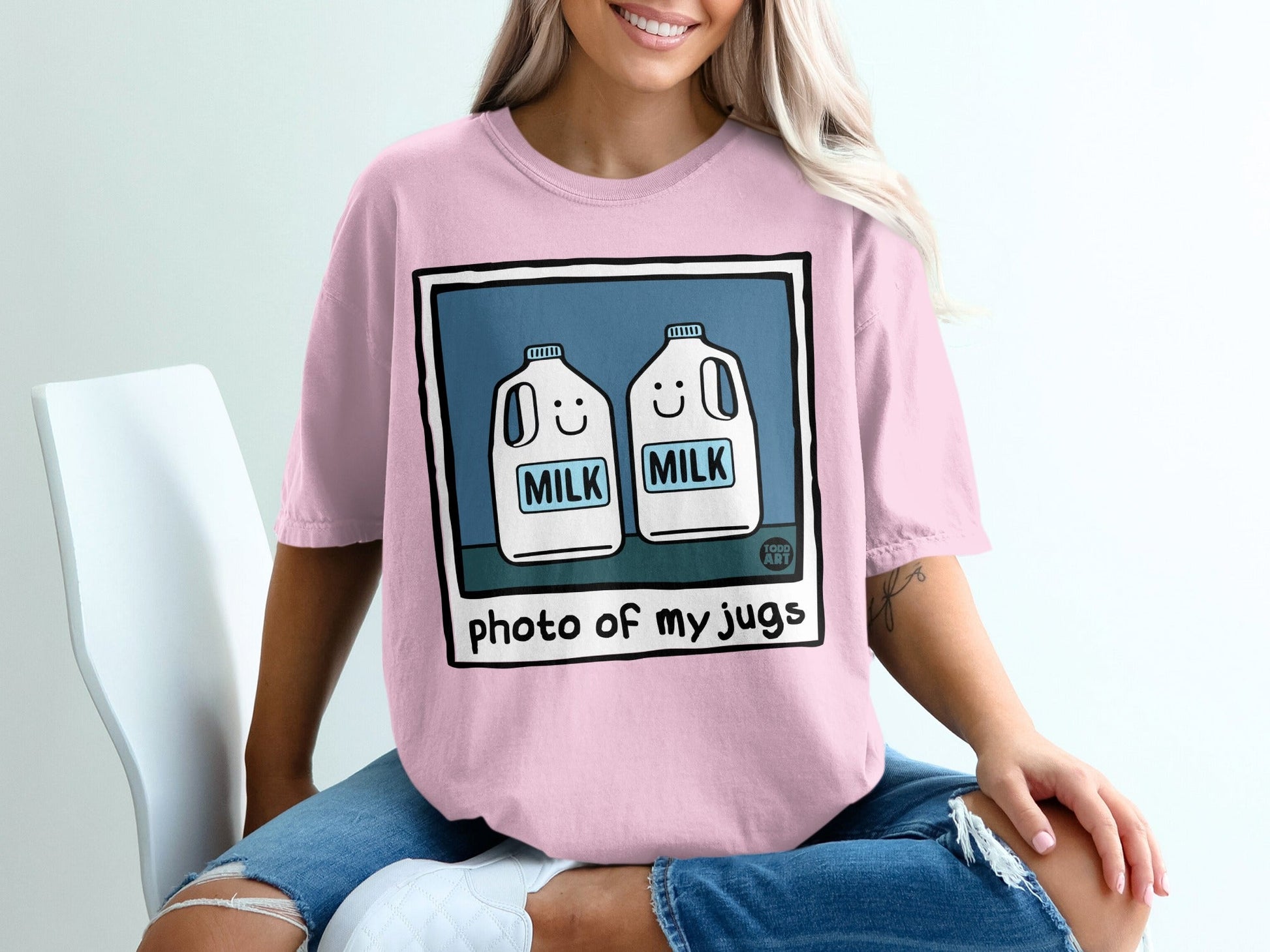 Pink t-shirt with cartoon milk jugs and "photo of my jugs" text.