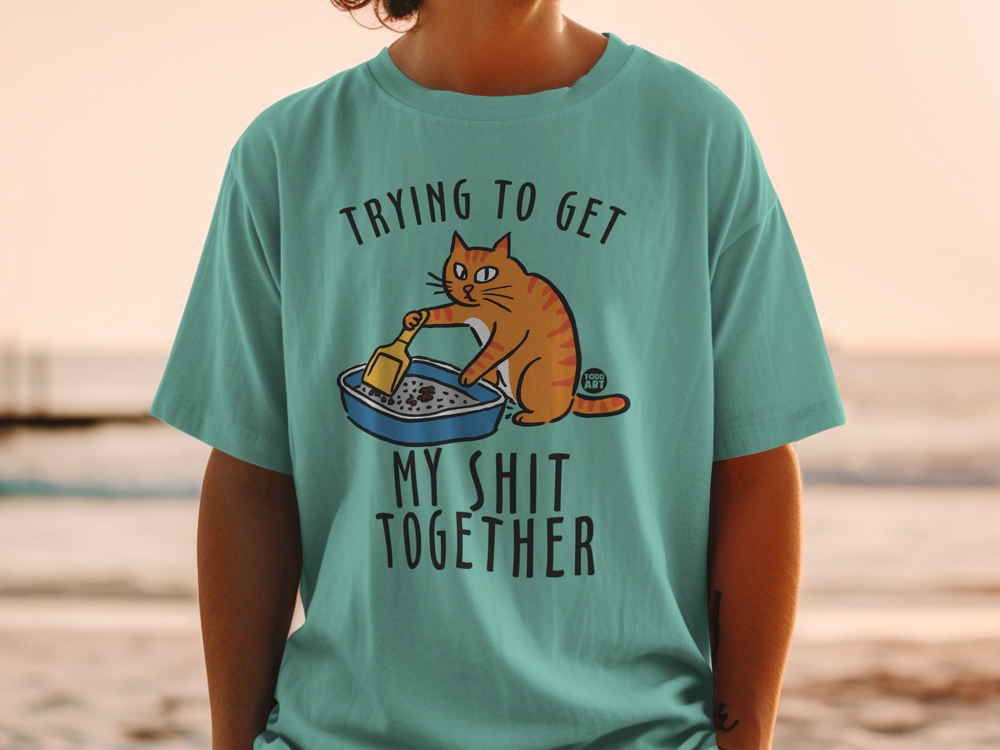 Cartoon cat in litter box with text "Trying to get my shit together".