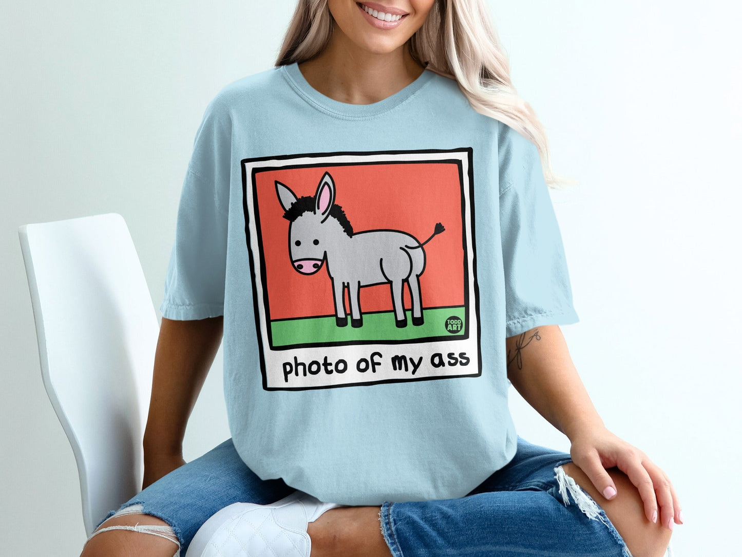 Light blue t-shirt with a cartoon donkey illustration and text.