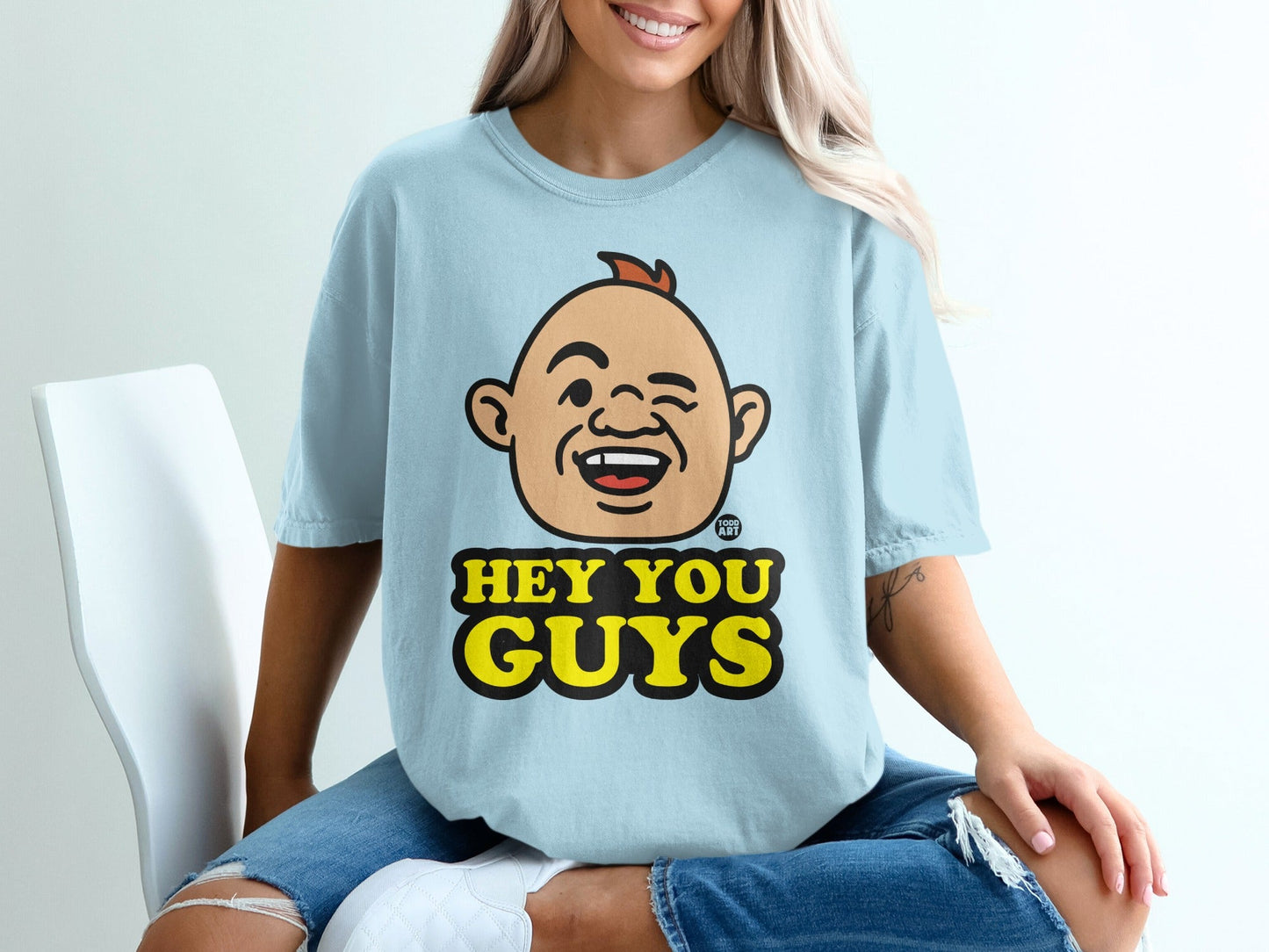 Light blue t-shirt with cartoon character saying "Hey You Guys."