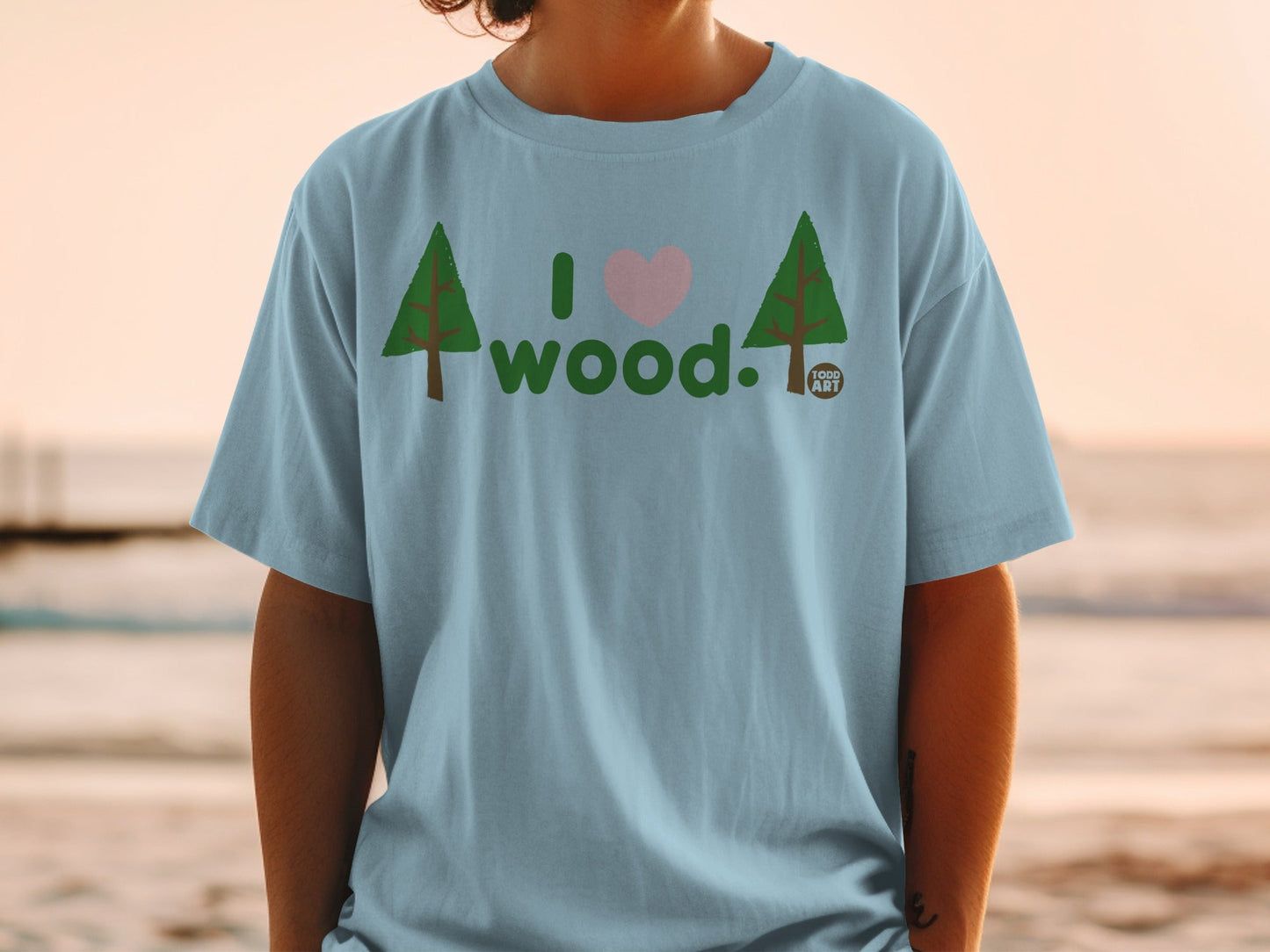 Light blue t-shirt with "I love wood" and two trees, one heart.