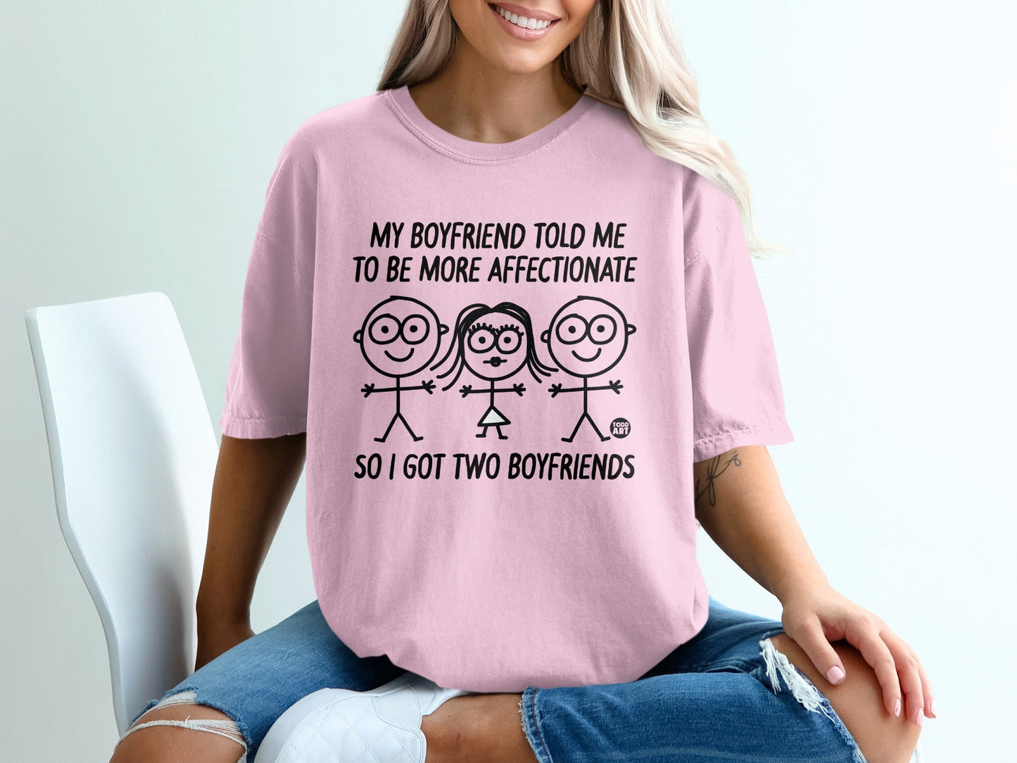 Pink t-shirt with graphic text "SO I GOT TWO BOYFRIENDS" and stick figures.