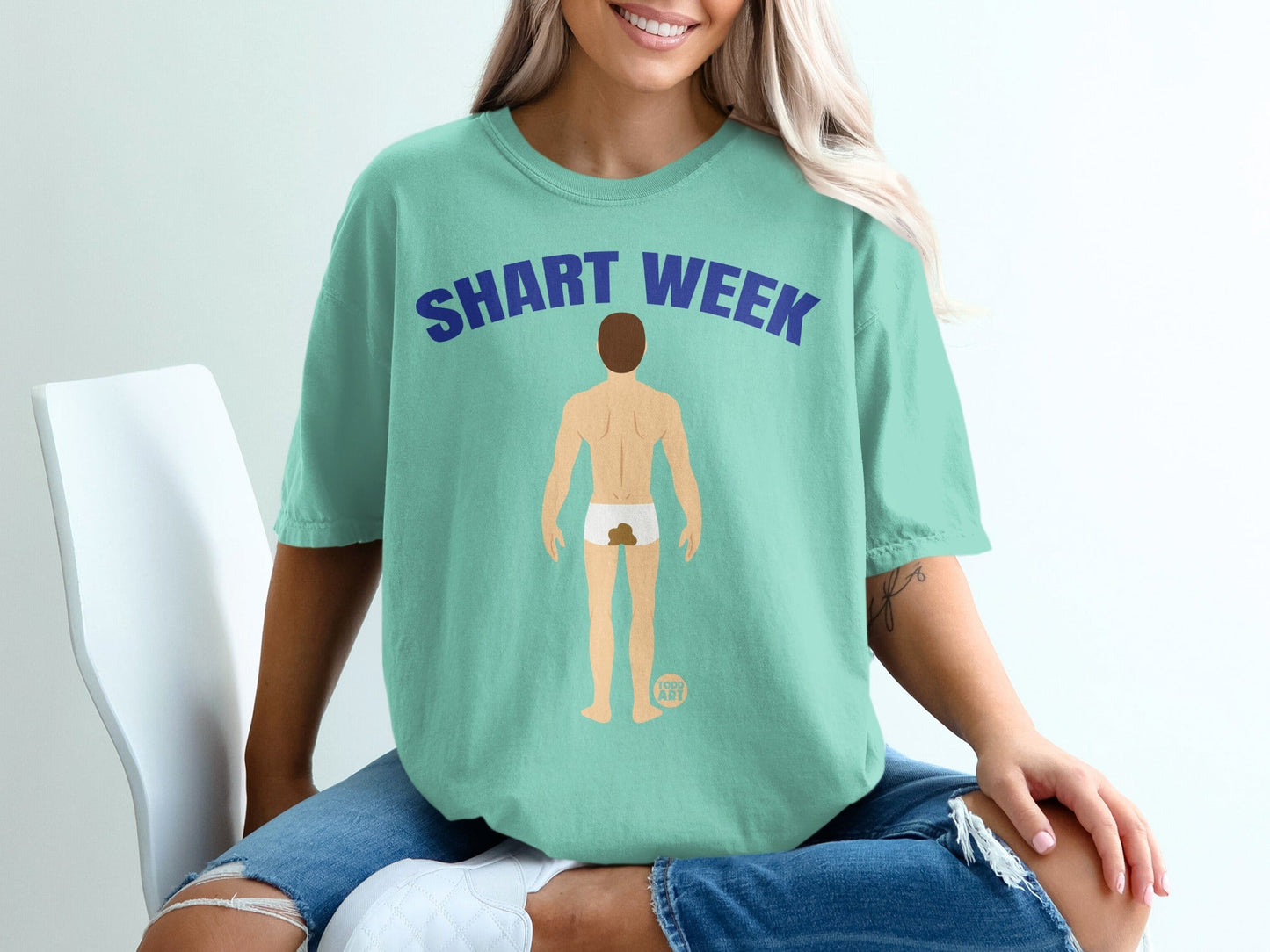 Teal t-shirt with "SHART WEEK" graphic of a man's backside.