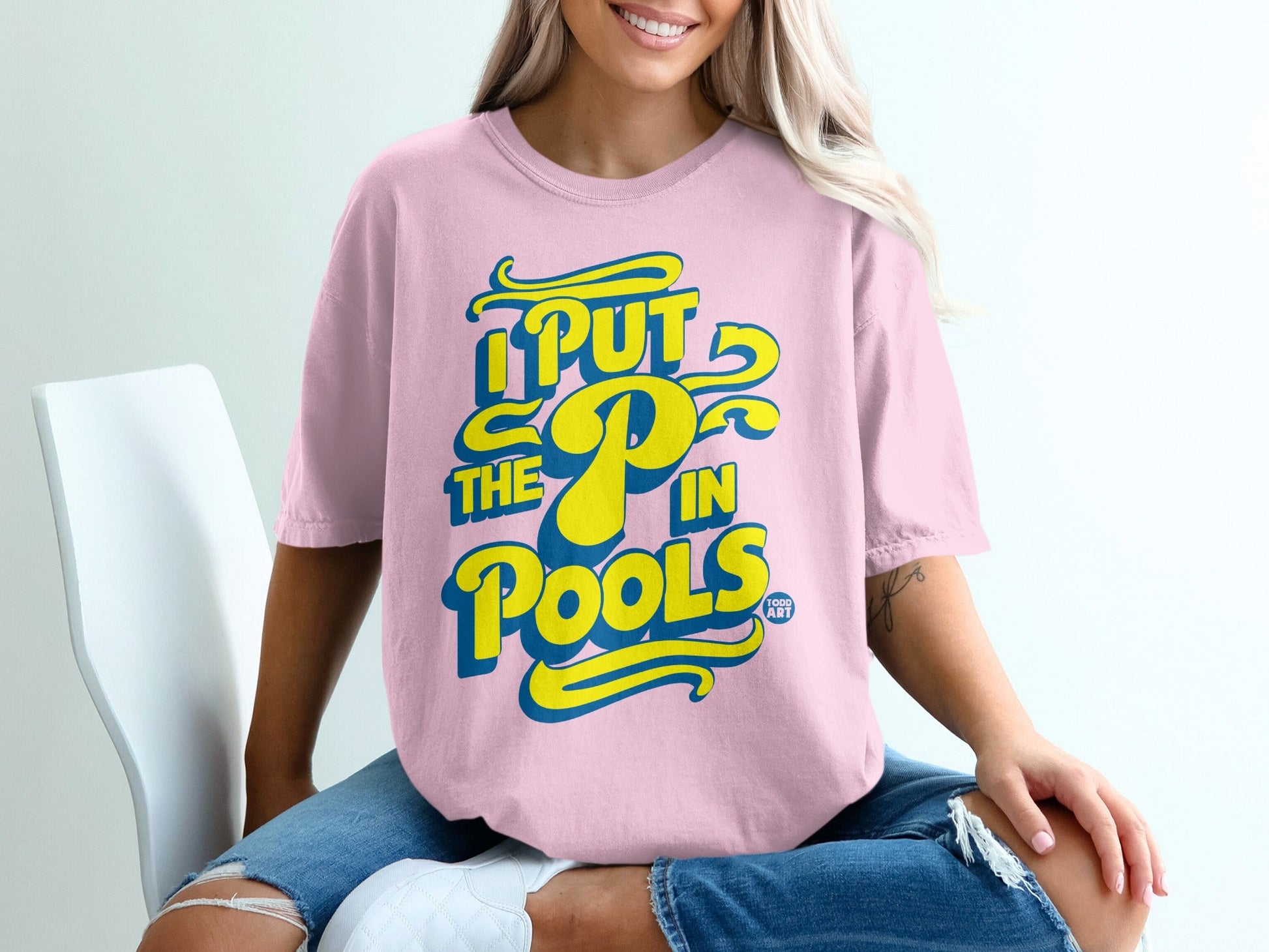 Pink t-shirt with blue and yellow text "I PUT THE P IN POOLS"