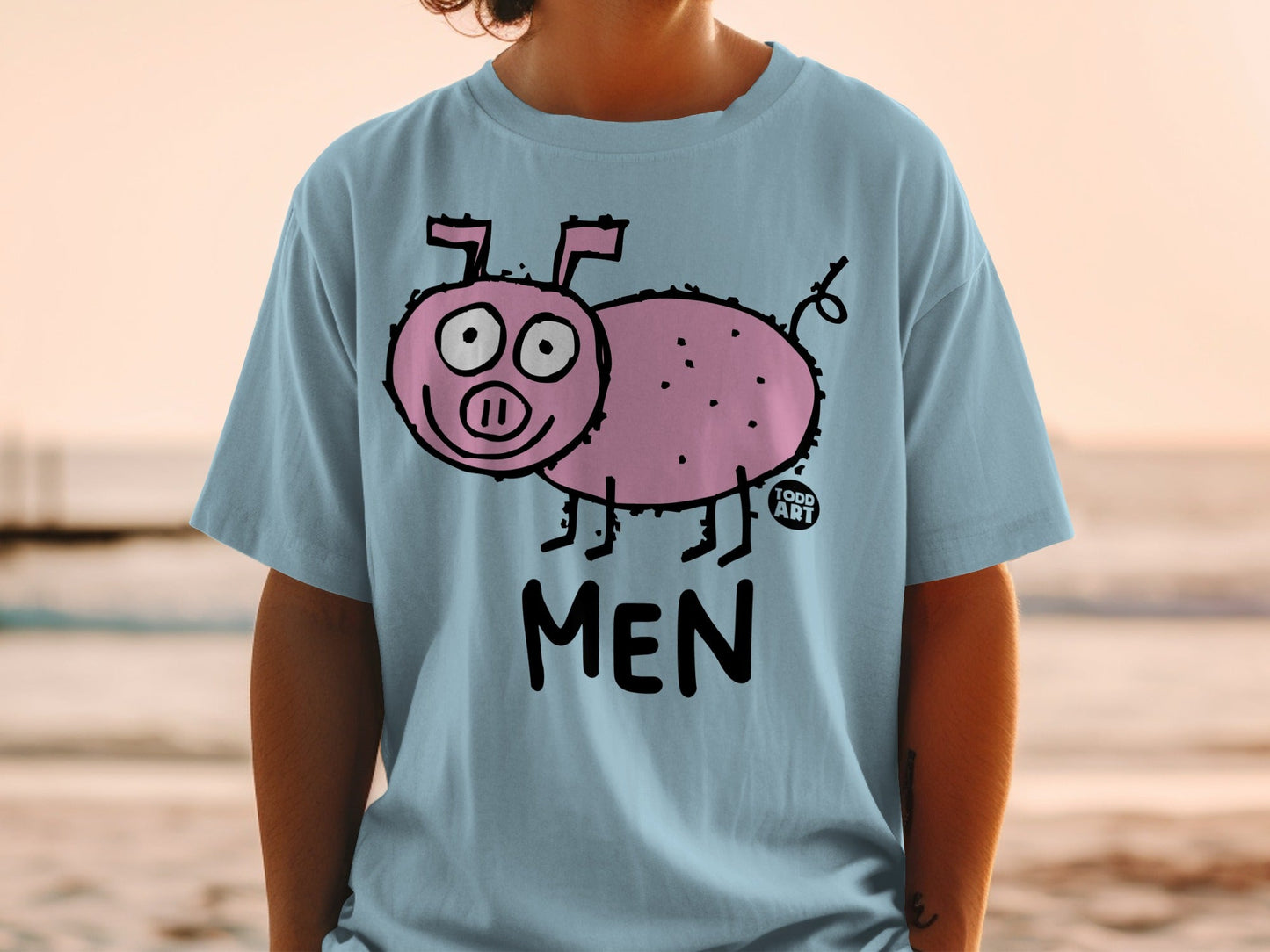 Light blue t-shirt with cartoon pink pig graphic and "MEN" text.