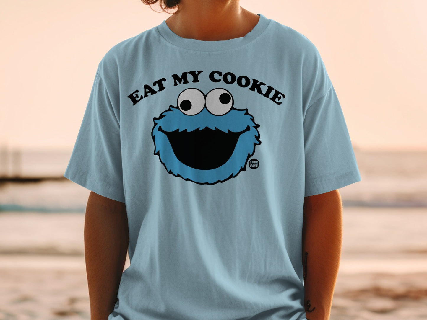 Light blue t-shirt with "Eat My Cookie" text and Cookie Monster graphic.