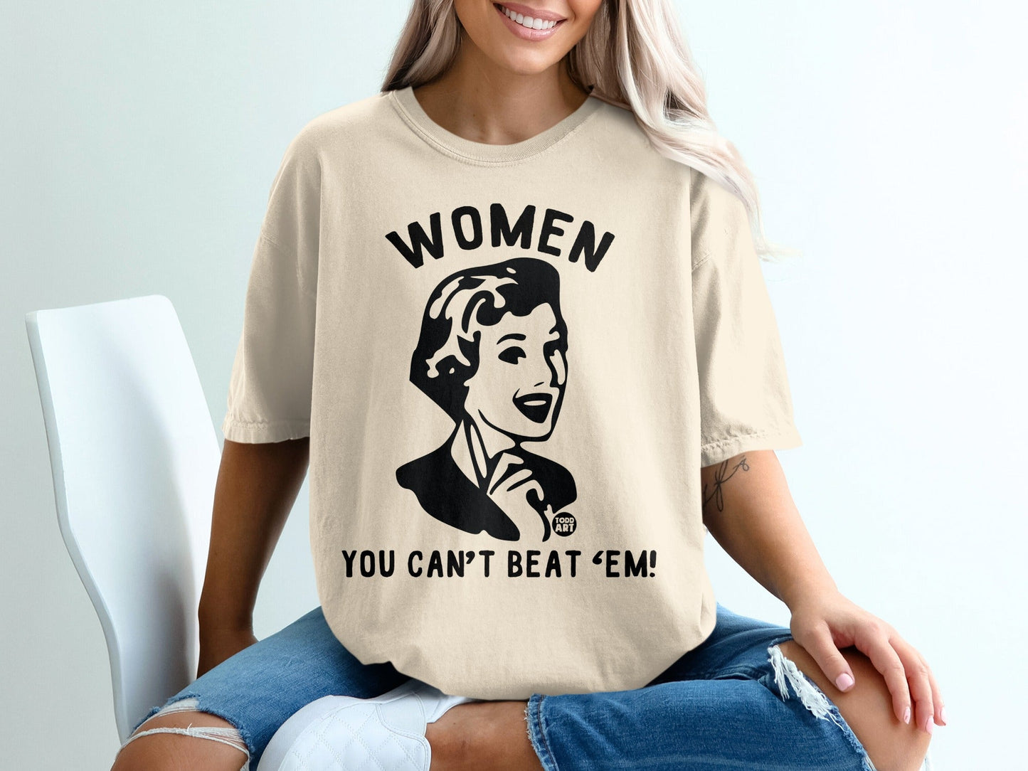Cream t-shirt with "WOMEN YOU CAN'T BEAT 'EM!" text and graphic.