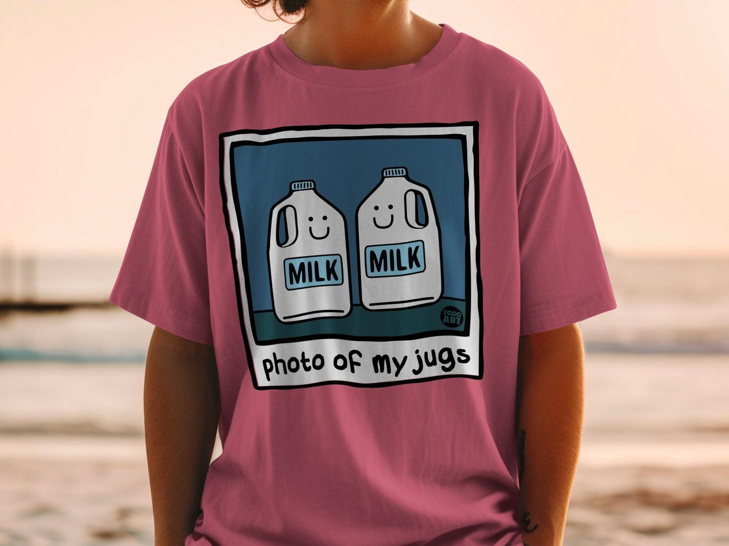 Pink t-shirt with cartoon milk jugs and the text "photo of my jugs".