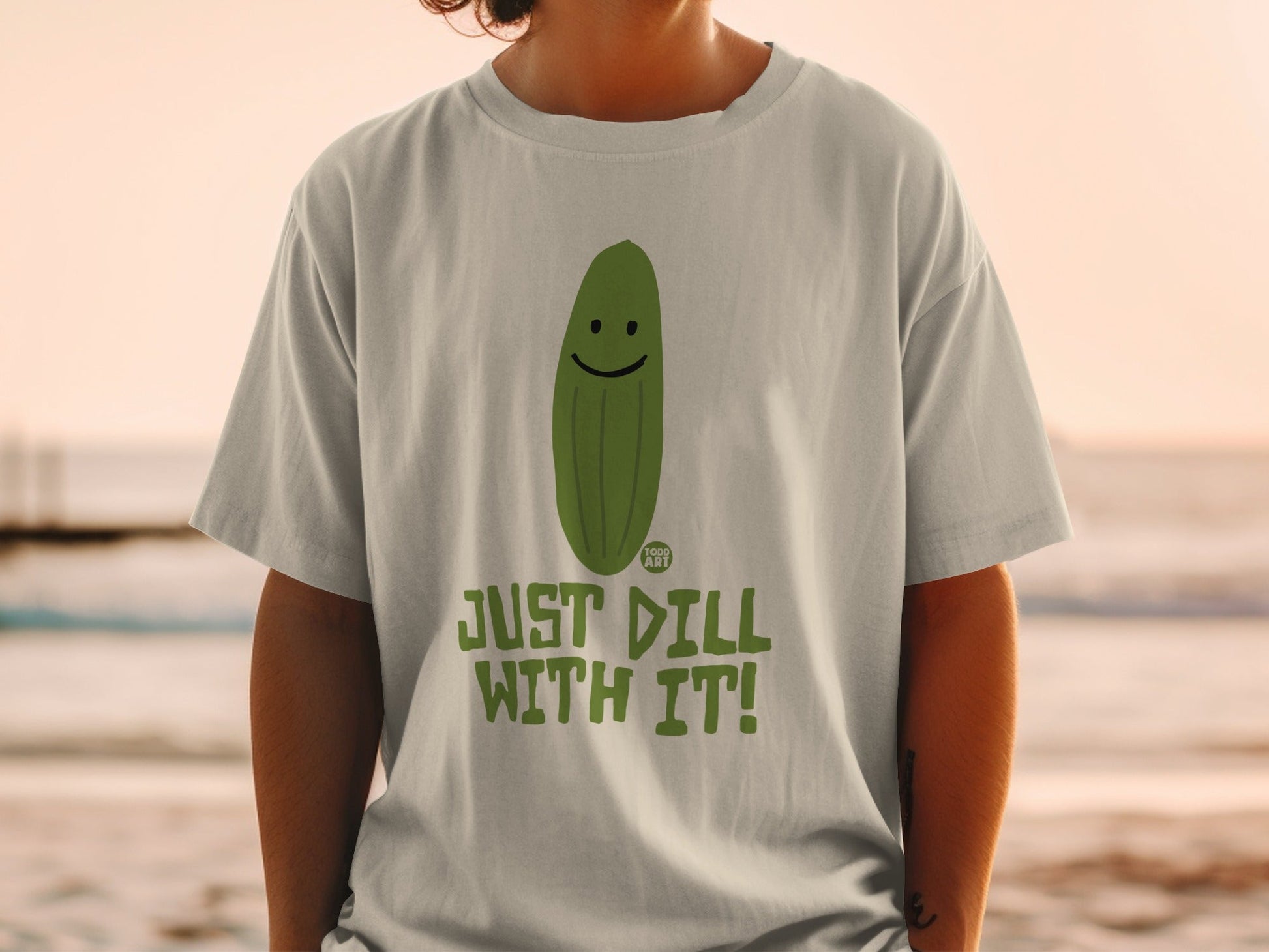 T-shirt with a smiling pickle and "JUST DILL WITH IT!" text.