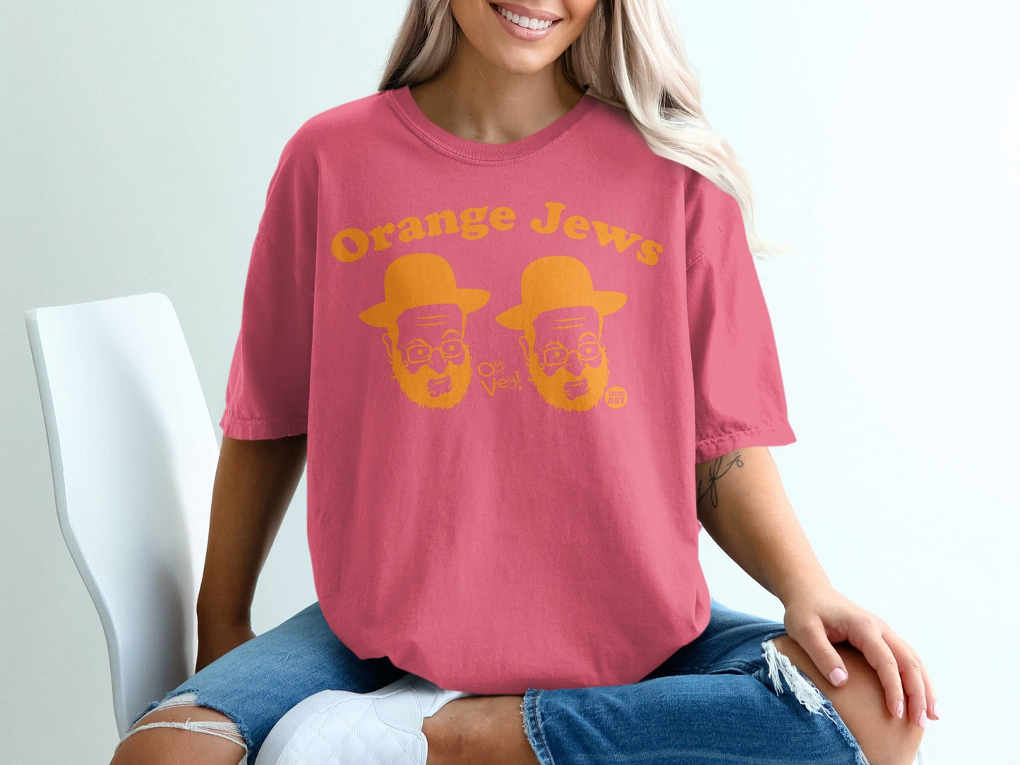Pink t-shirt with "Orange Jews" text and two cartoon faces.