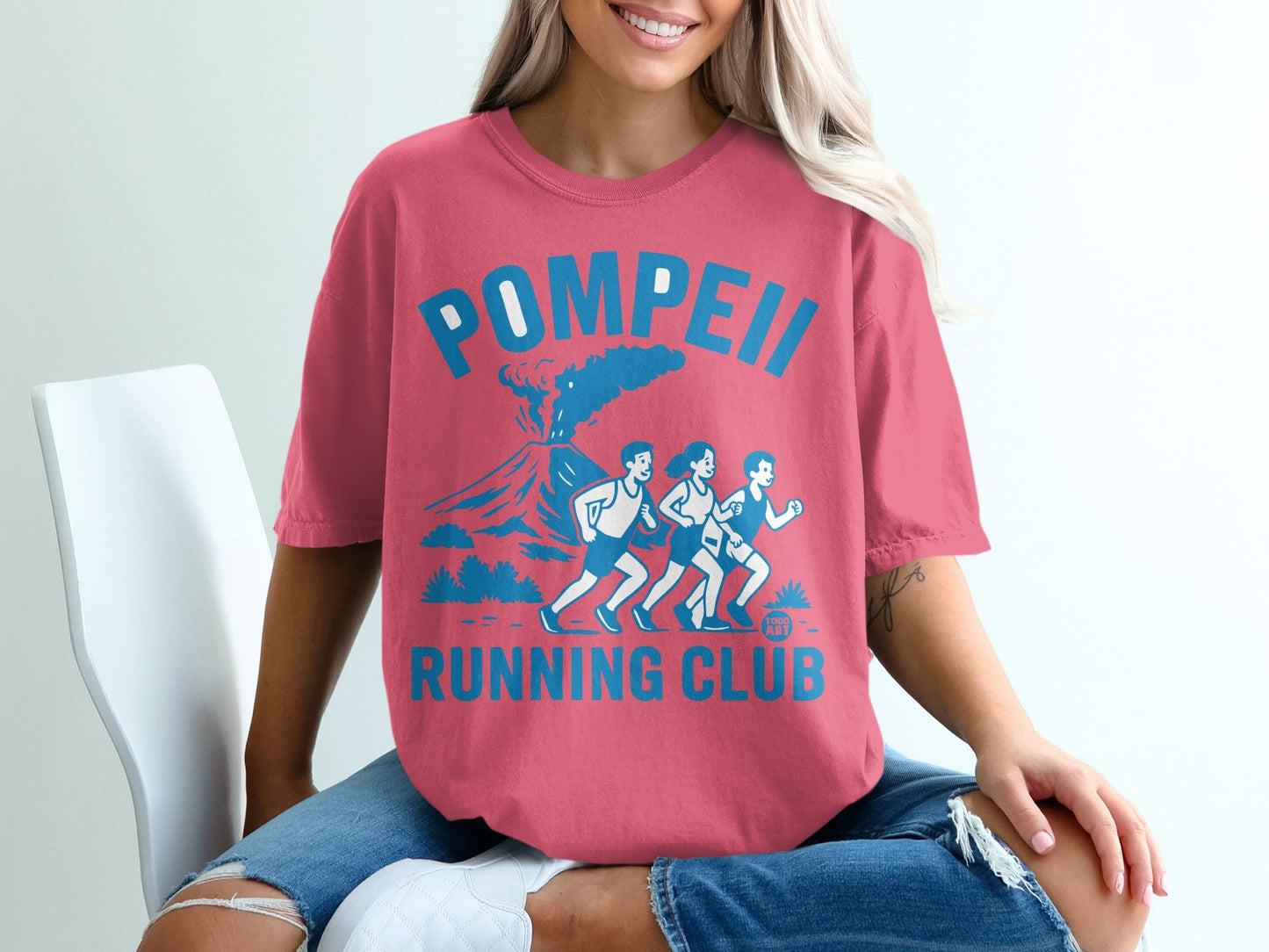 Pink t-shirt with "Pompeii Running Club" and volcano graphic.